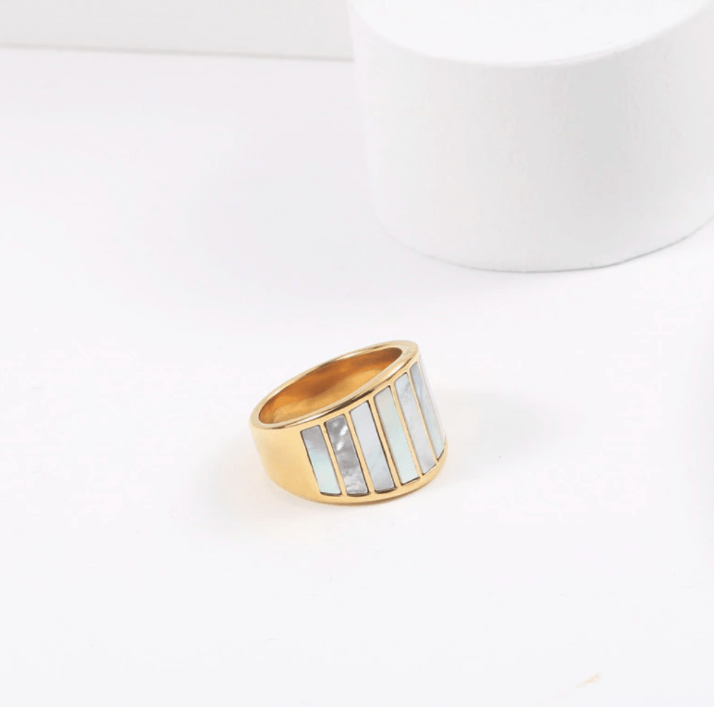 Stella Mother of Pearl Statement Ring featuring a bold geometric design with natural white shell stones and 18K gold plating.