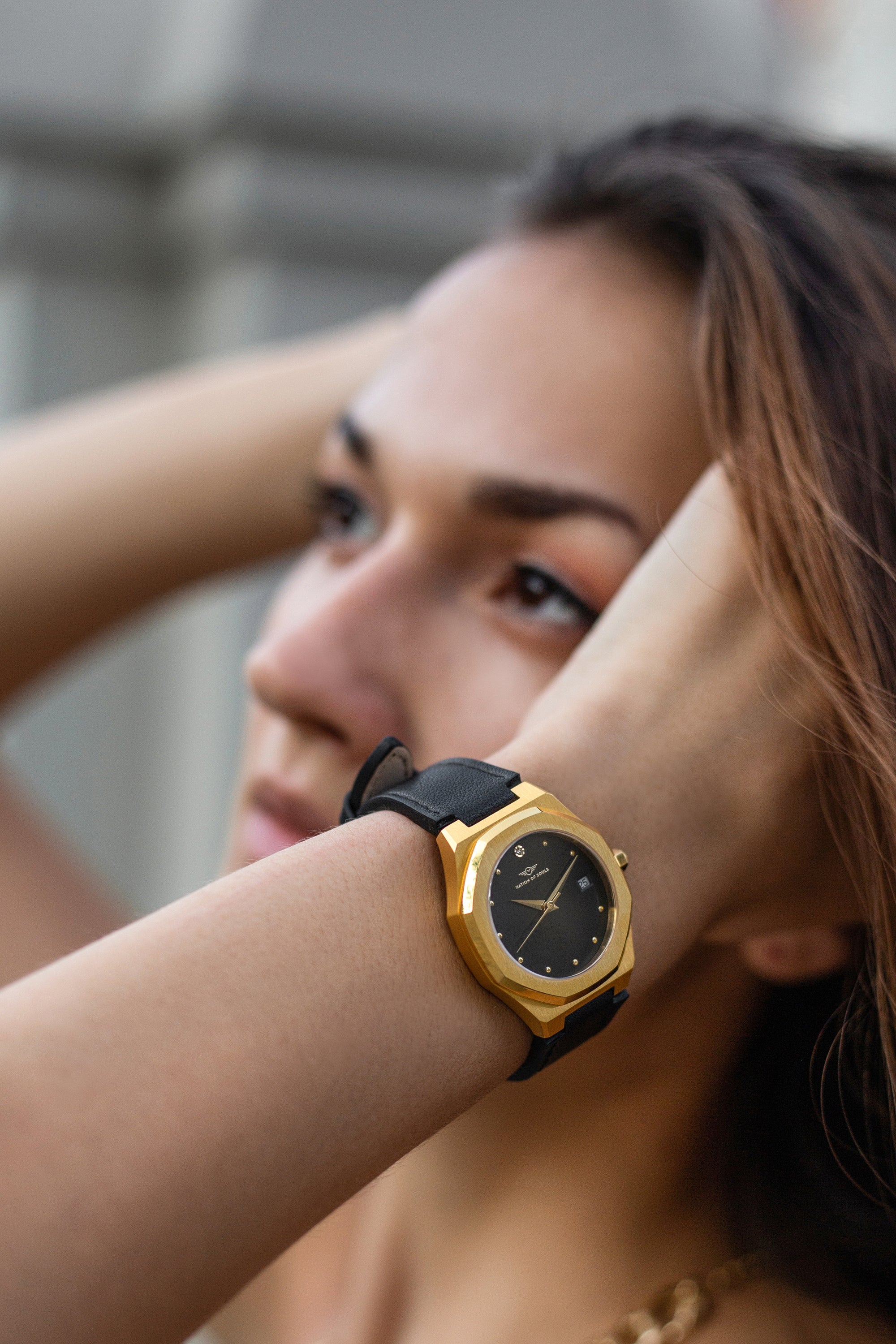 Stellar Gold-Black watch featuring a stainless steel case, Sunray dial, and stud hour markers.