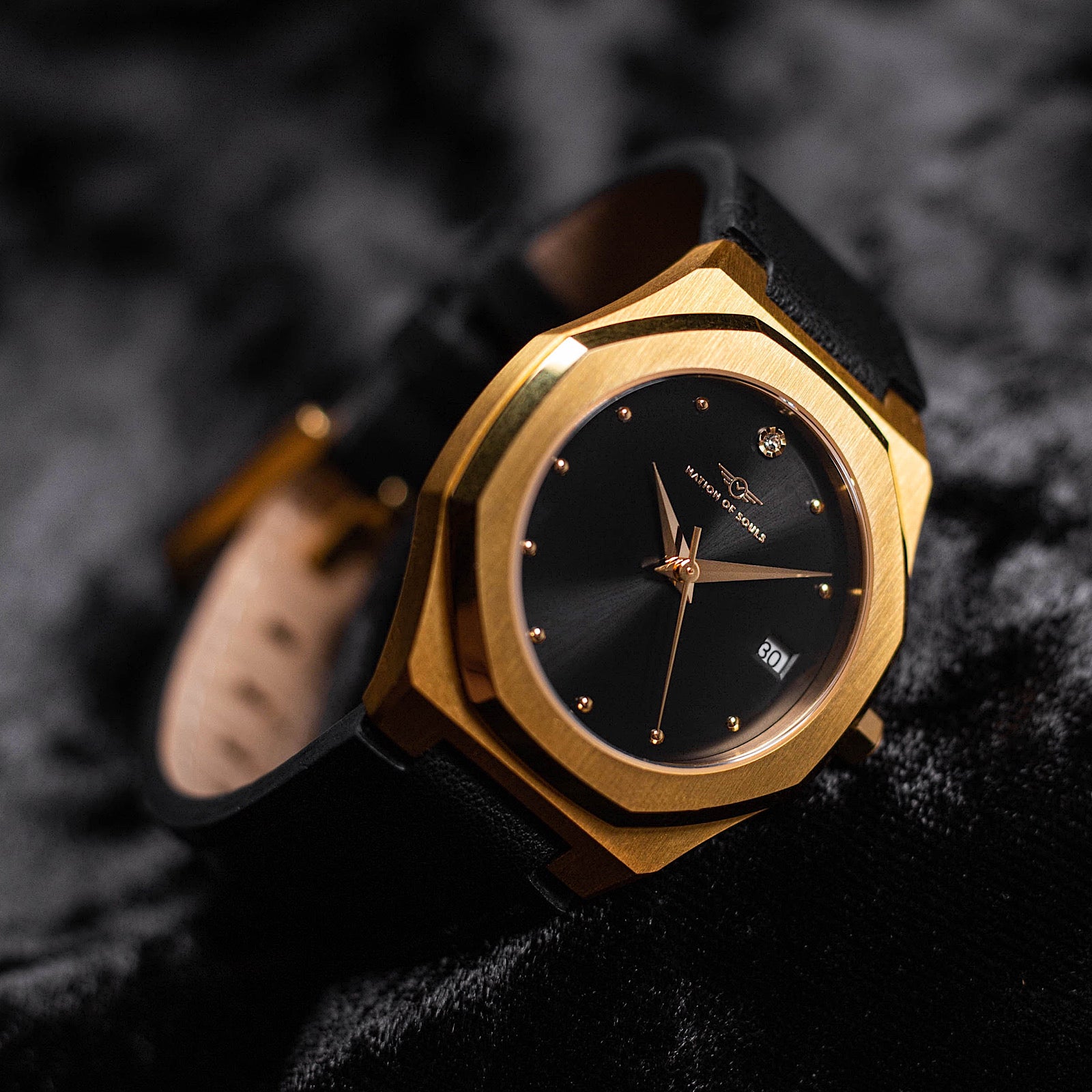 Stellar Gold-Black watch featuring a stainless steel case, Sunray dial, and stud hour markers.