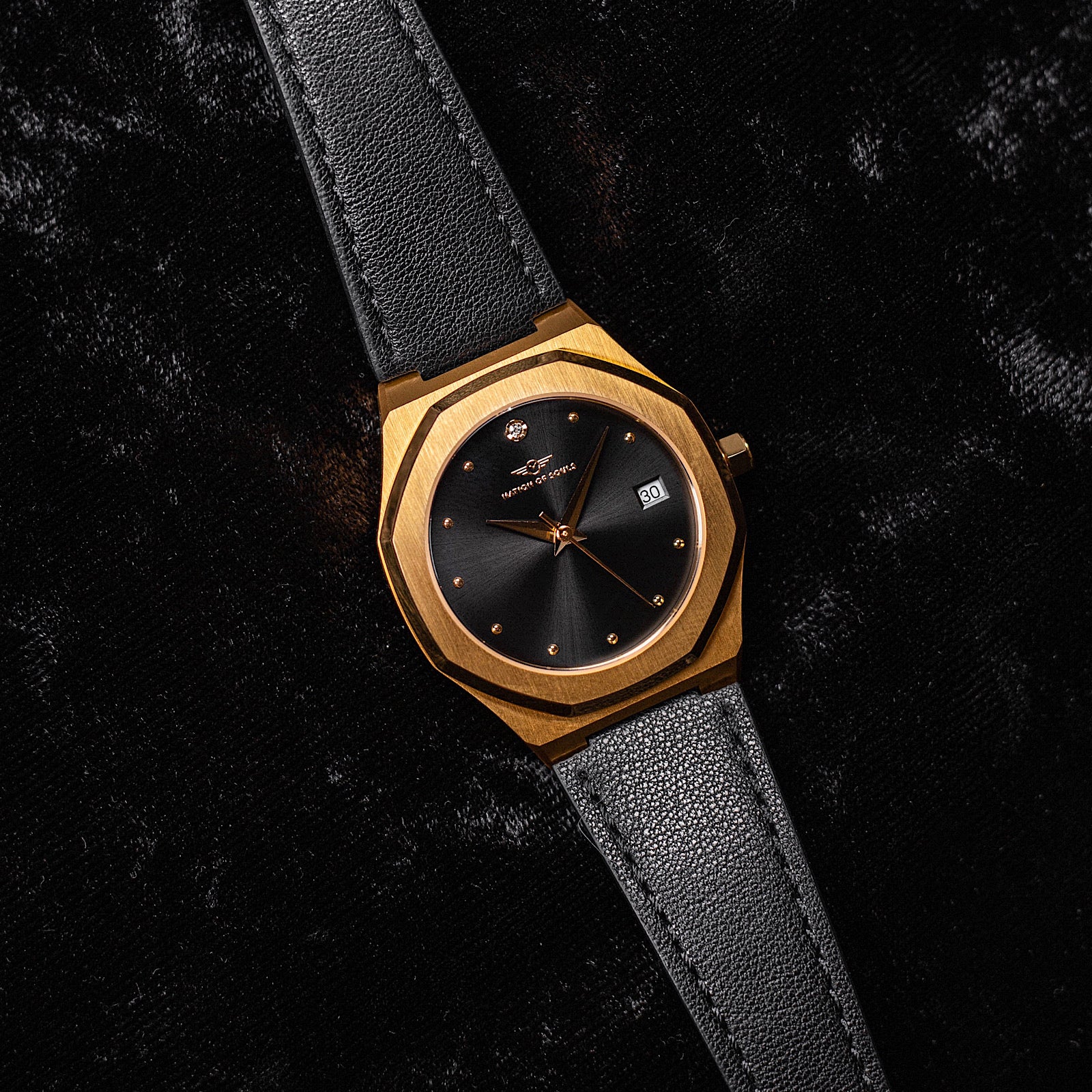 Stellar Gold-Black watch featuring a stainless steel case, Sunray dial, and stud hour markers.