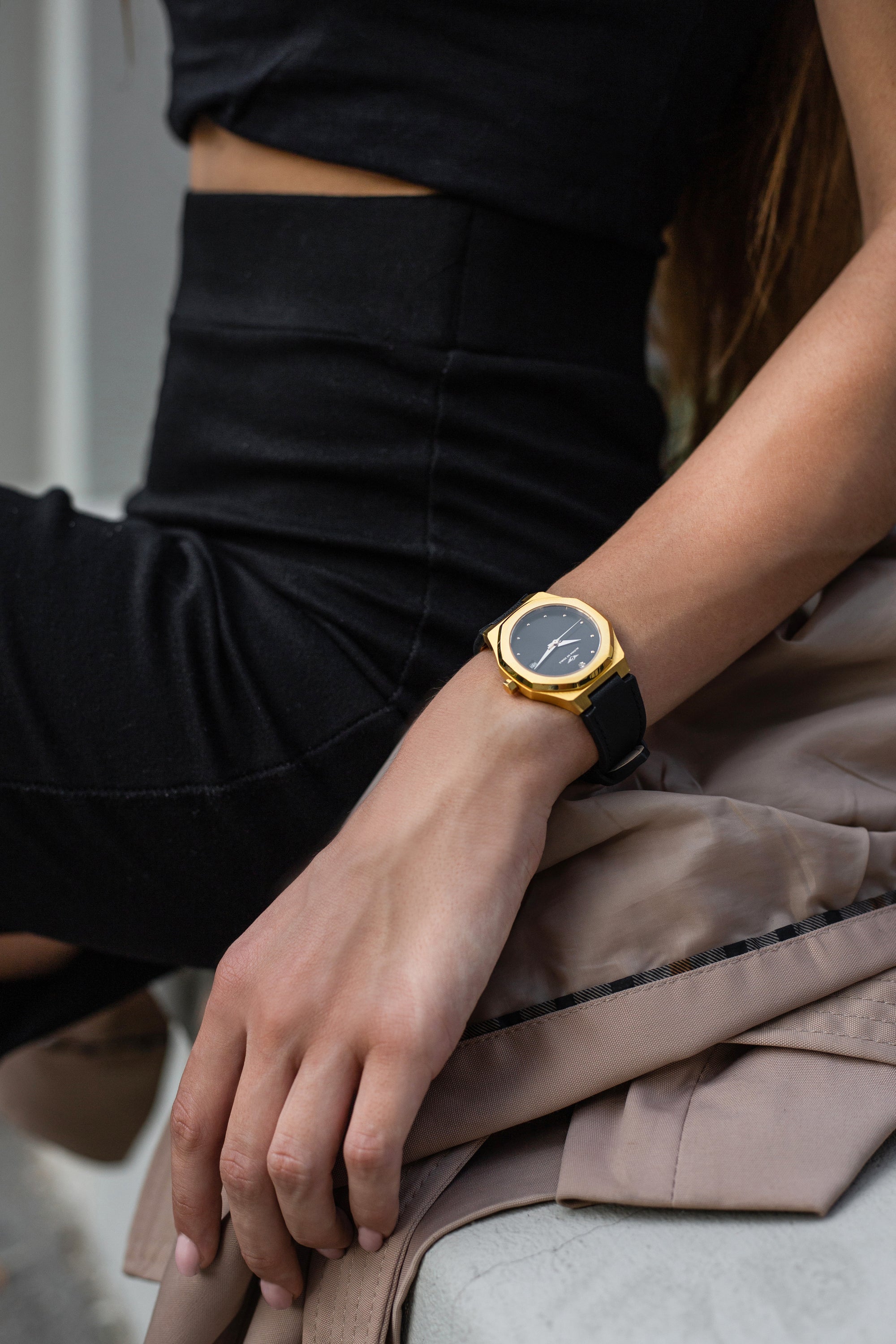 Stellar Gold-Black watch featuring a stainless steel case, Sunray dial, and stud hour markers.