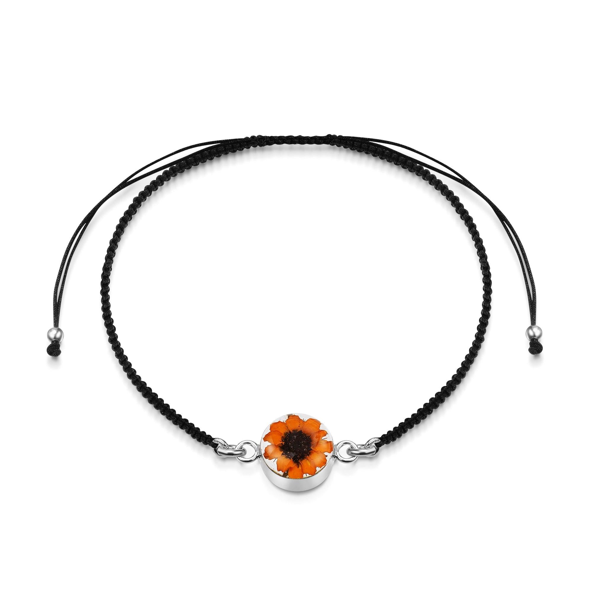 Sterling silver black woven bracelet featuring a sunflower charm, showcasing intricate details and elegant design.