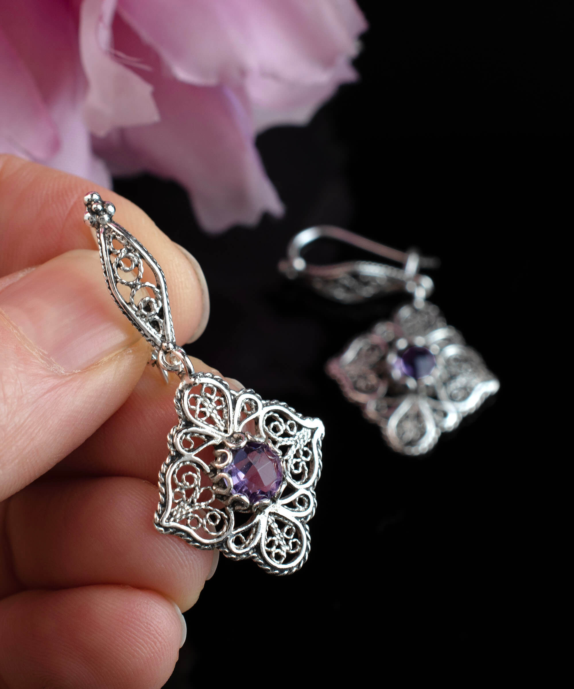 Sterling silver dangle drop earrings featuring intricate filigree art and purple Amethyst gemstones.