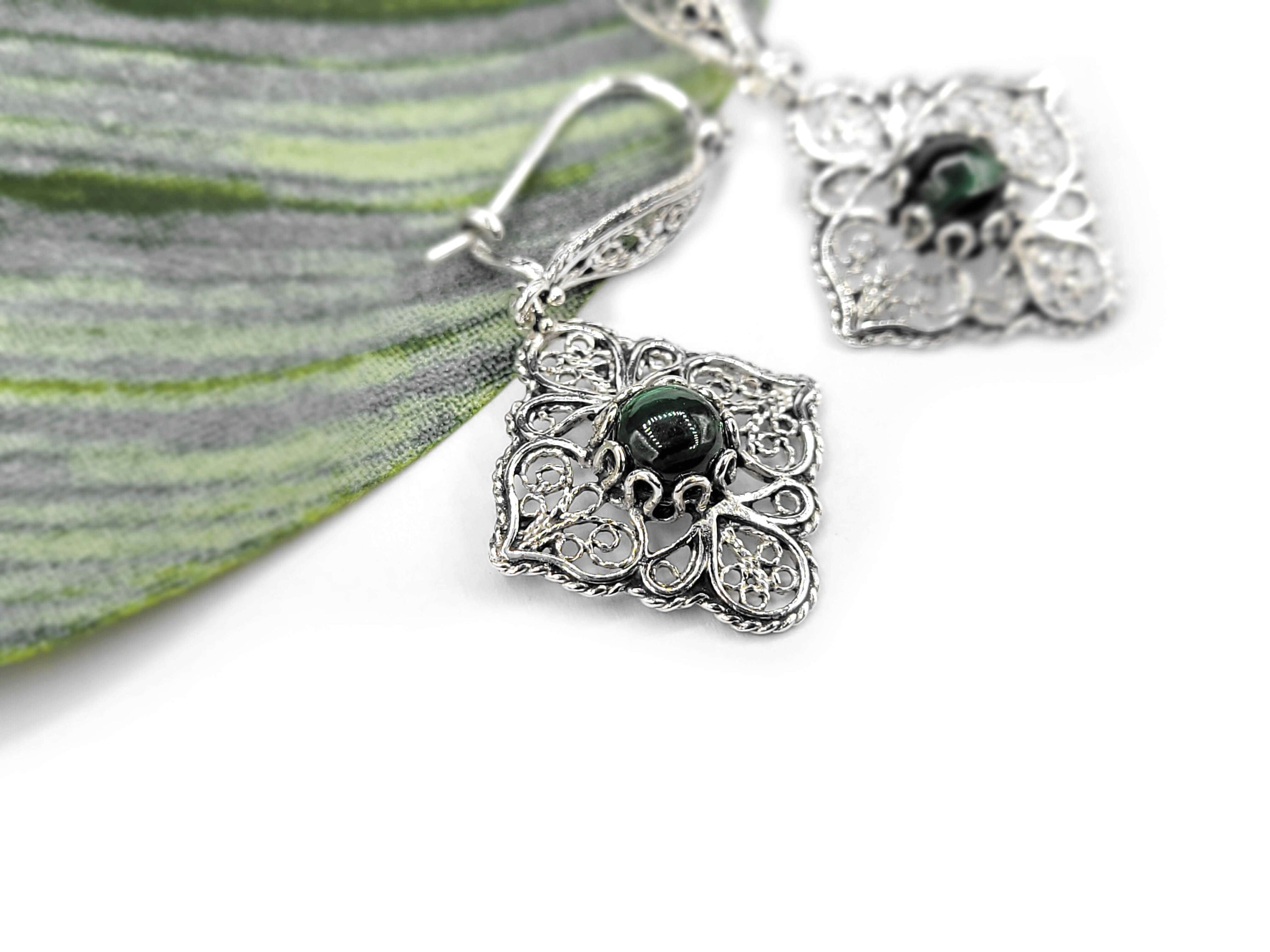 Elegant sterling silver dangle drop earrings featuring intricate filigree art and round cut Malachite gemstones, perfect for women.