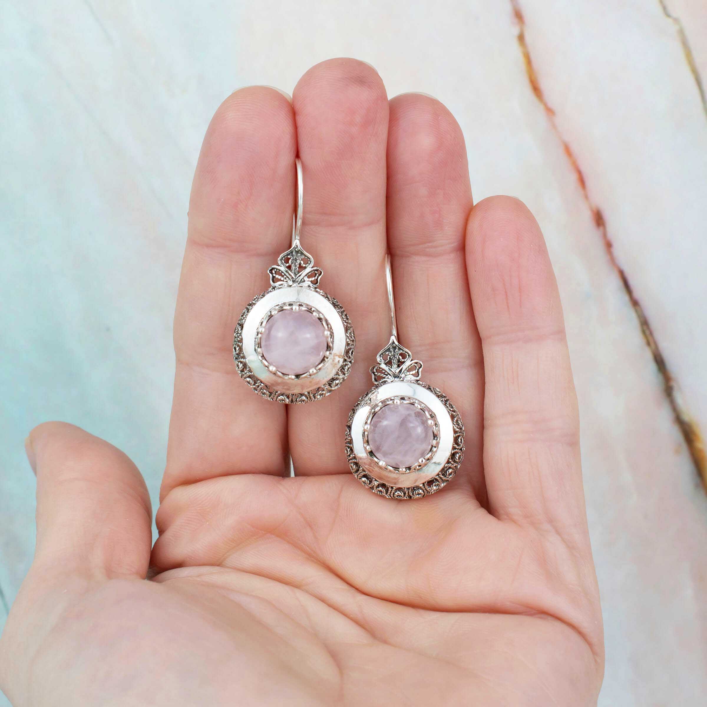 Sterling Silver Filigree Art Drop Earrings featuring a round-cut rose quartz gemstone, showcasing intricate metalwork and elegant design.