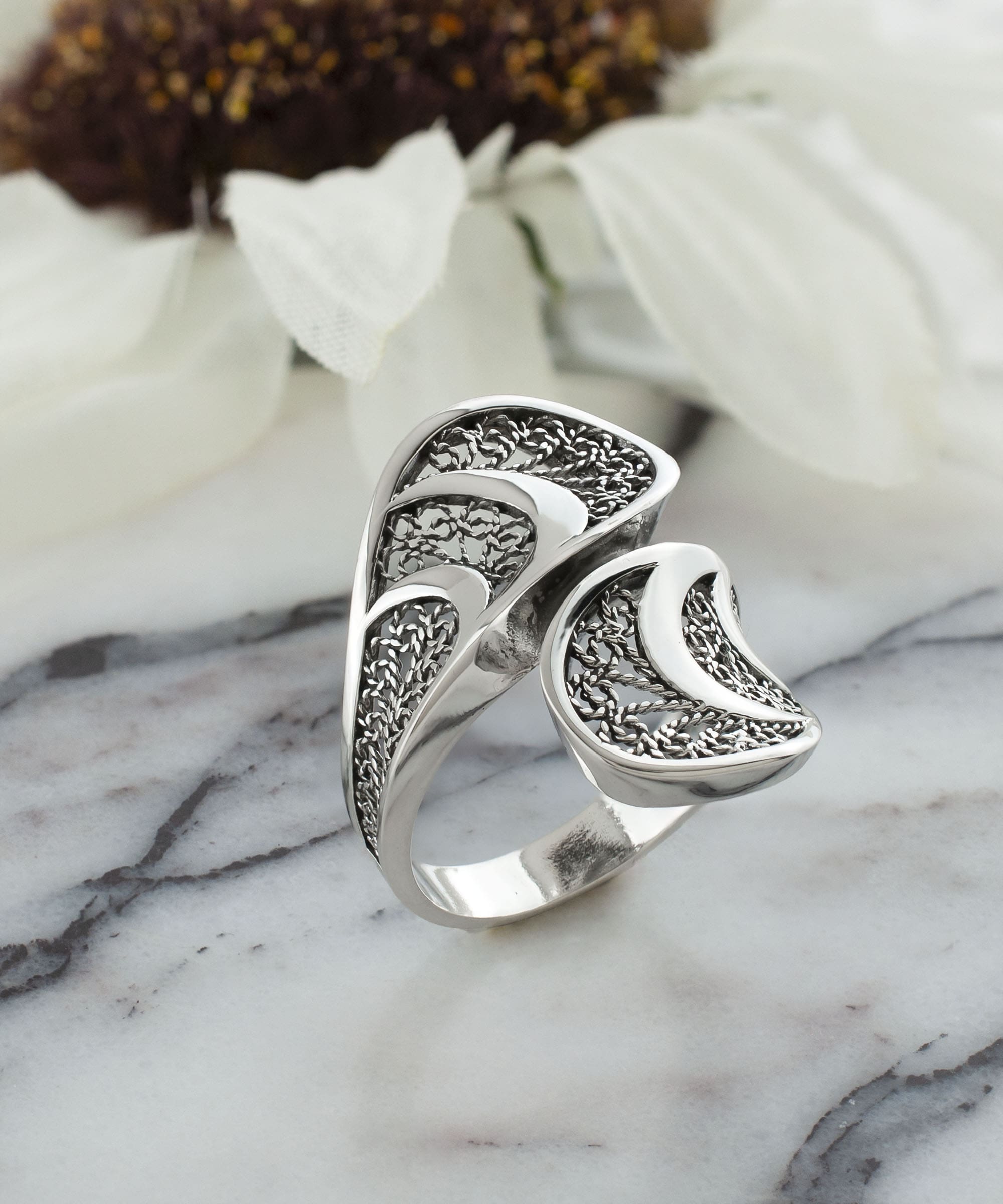 Sterling Silver Filigree Art Twisted Bypass Cocktail Ring showcasing intricate filigree design and elegant twisted shape.