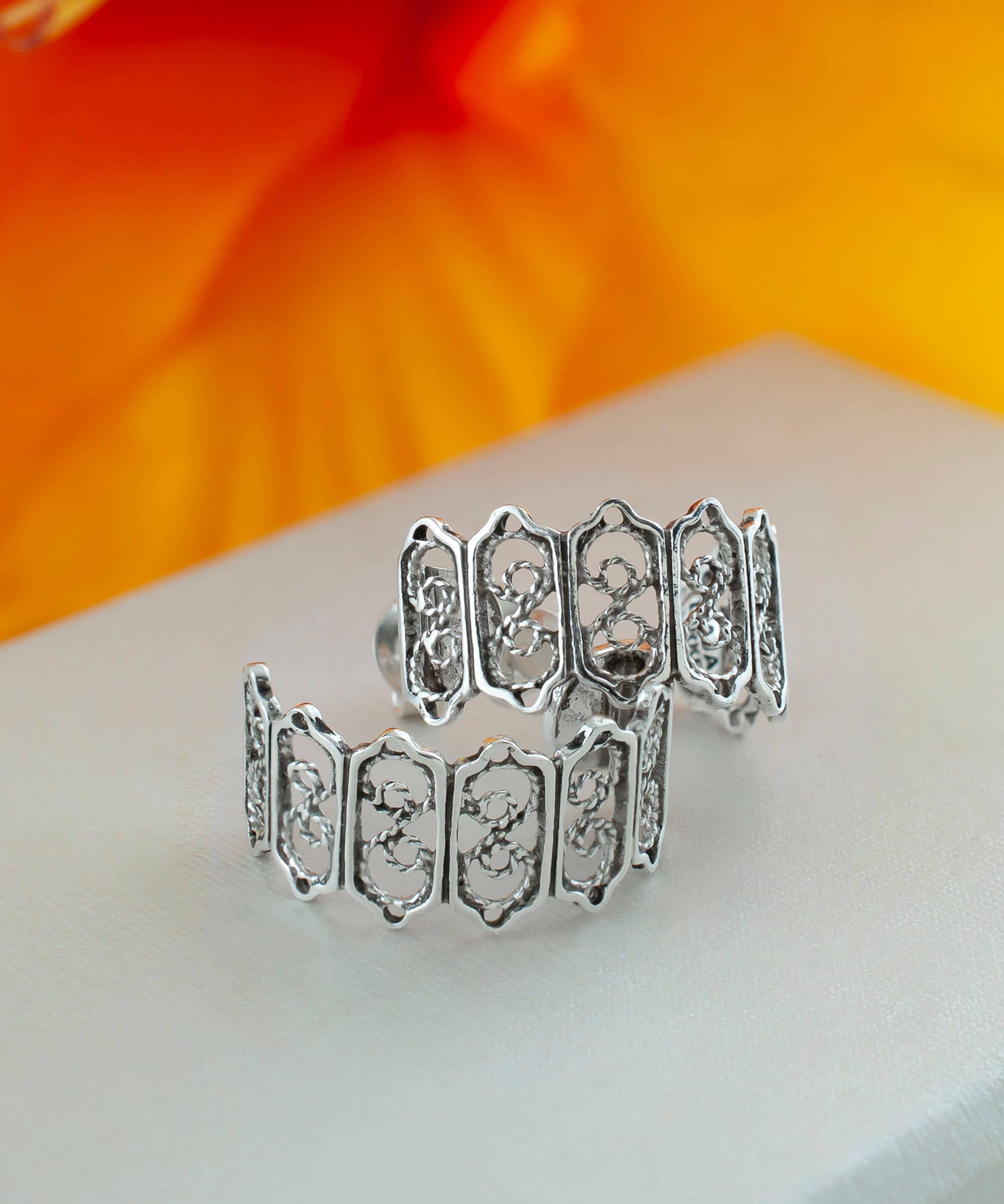 Sterling Silver Filigree C-Hoop Stud Earrings showcasing intricate design and polished finish.