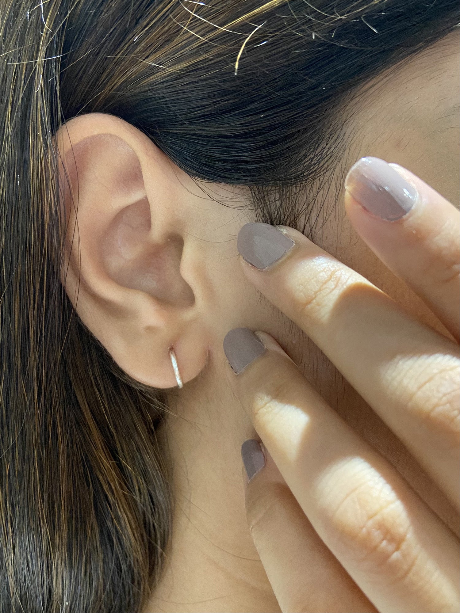 A pair of Sterling Silver Huggie Hoops showcasing their elegant design and quality craftsmanship, available in silver, gold, and rose gold.