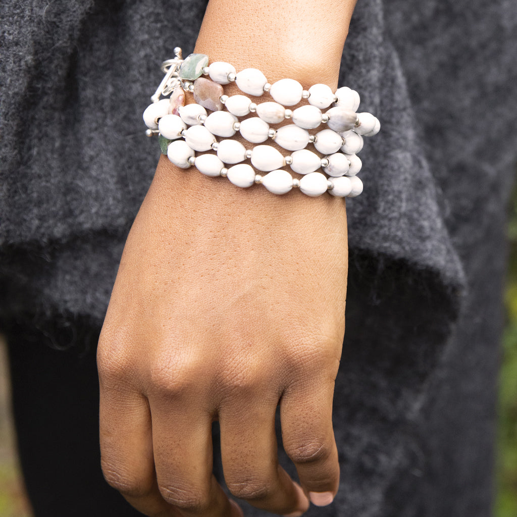 Sterling Silver Majok Stackable Bracelet featuring cream and grey-toned Haitian majok seeds, sterling silver beads, and jasper gemstones.