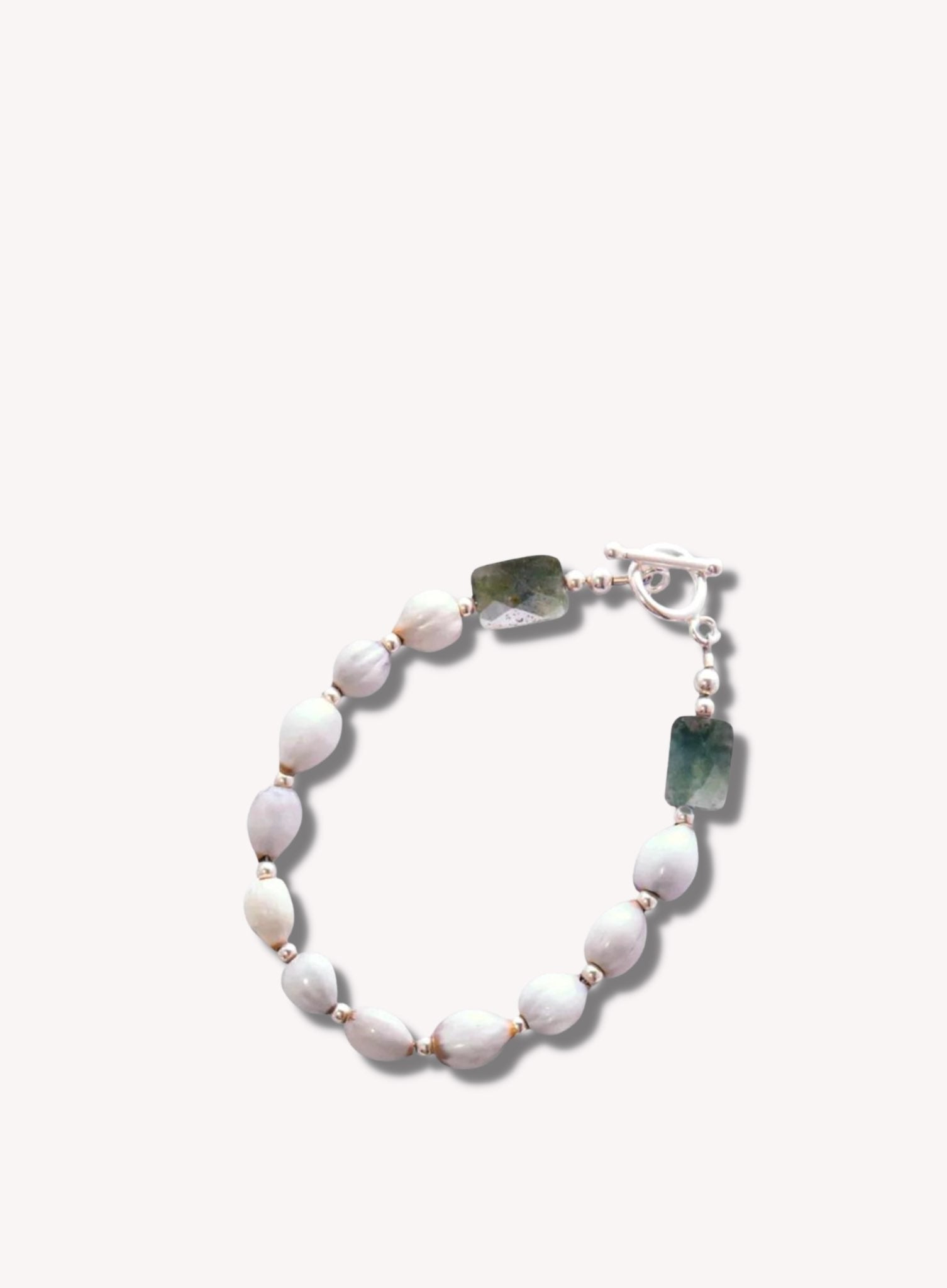 Sterling Silver Majok Stackable Bracelet featuring cream and grey-toned Haitian majok seeds, sterling silver beads, and jasper gemstones.