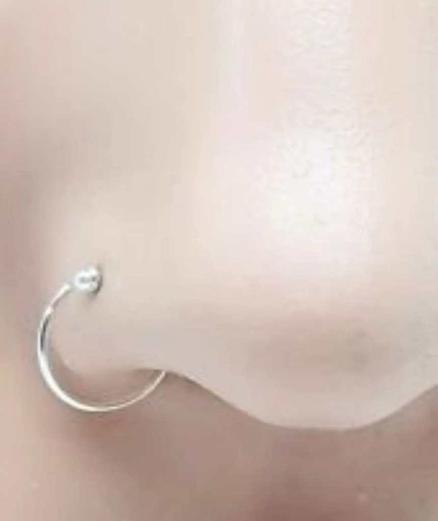 Elegant sterling silver nose ring with a secure ball closure, suitable for various piercings.