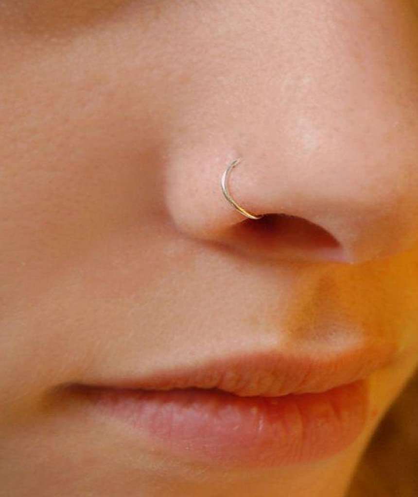 A classic sterling silver nose ring displayed elegantly, showcasing its shiny finish and simple design.