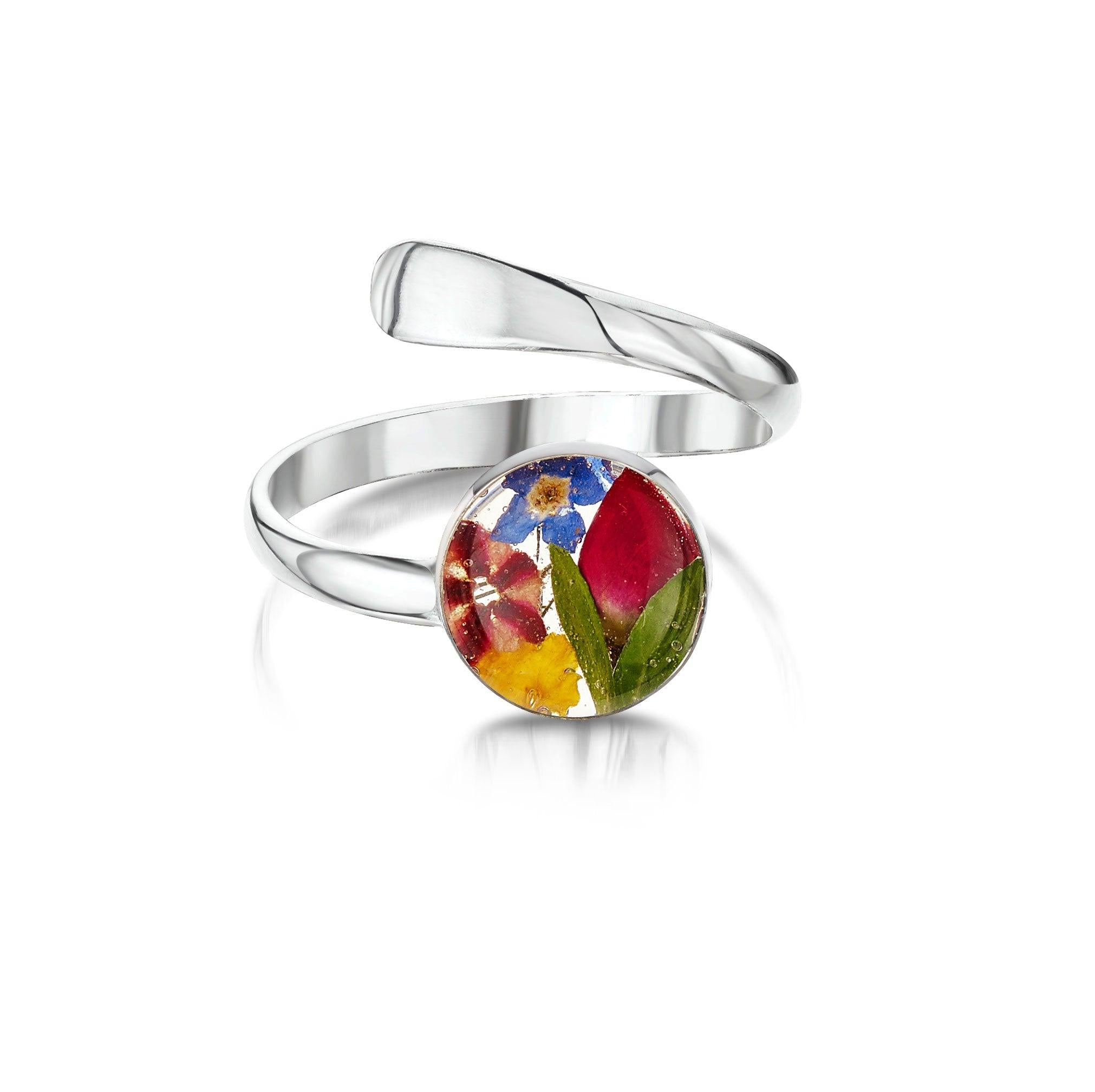 Adjustable sterling silver ring featuring real flowers in a round charm, elegantly displayed in a gift box.