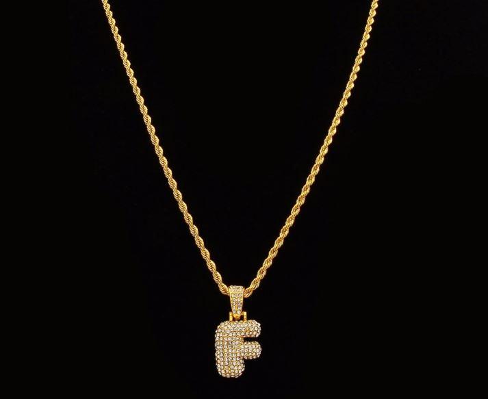 STILTR Steel Bubble Initial Necklace featuring a rhinestone-studded initial pendant on a 24-inch solid rope chain.