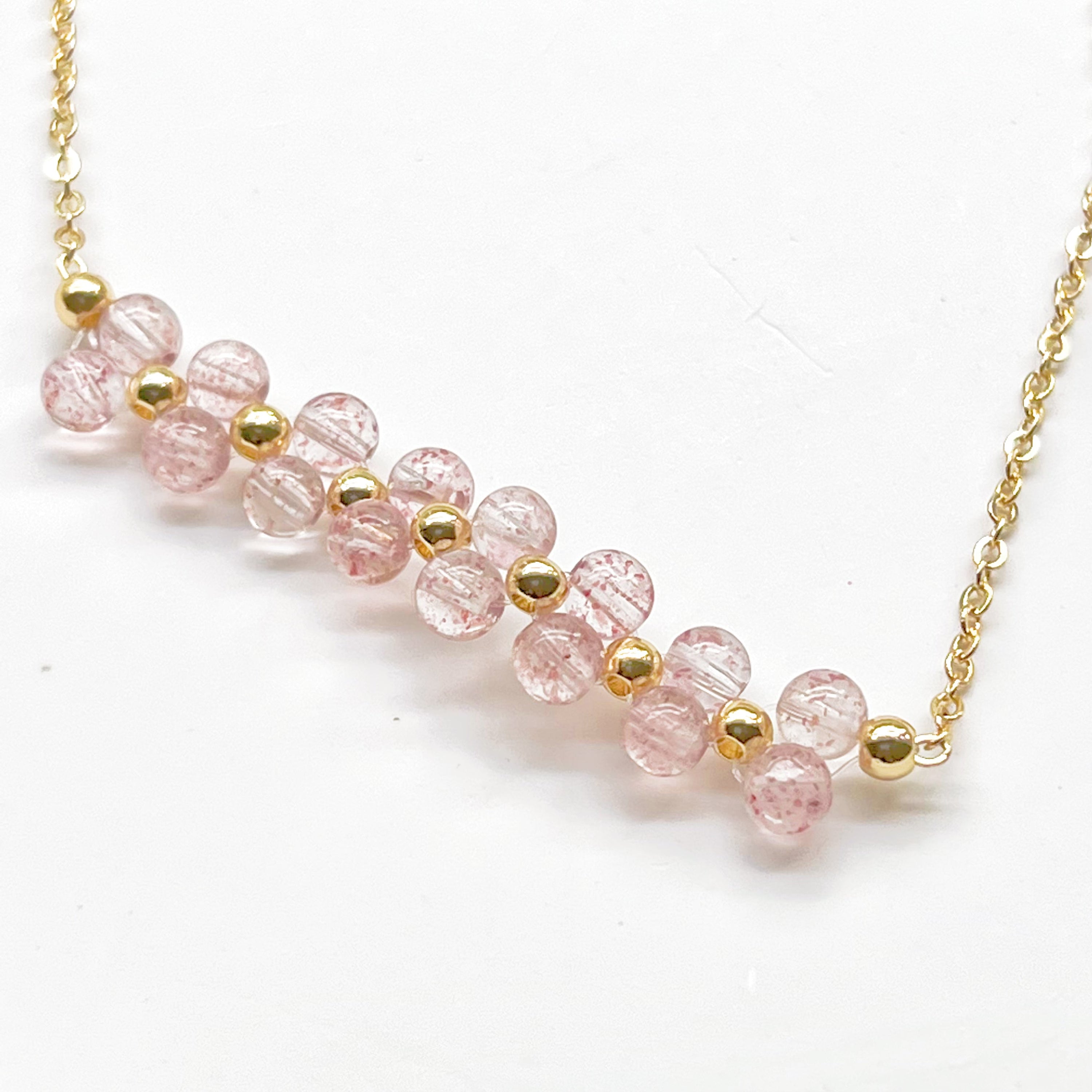 A beautifully handcrafted Strawberry Quartz Cluster Bracelet featuring natural pink quartz beads in a bar shape, elegantly displayed in a gift box.