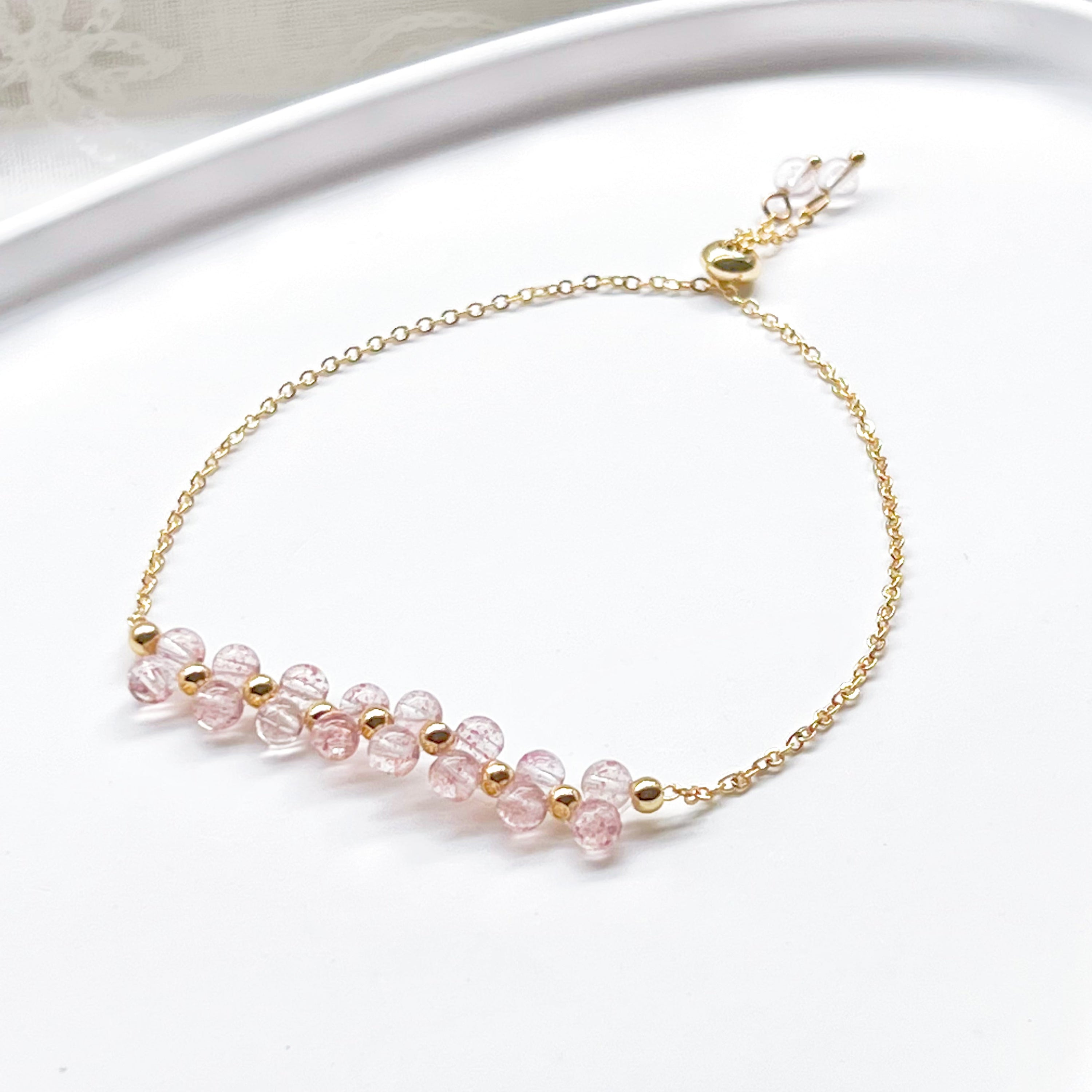 A beautifully handcrafted Strawberry Quartz Cluster Bracelet featuring natural pink quartz beads in a bar shape, elegantly displayed in a gift box.