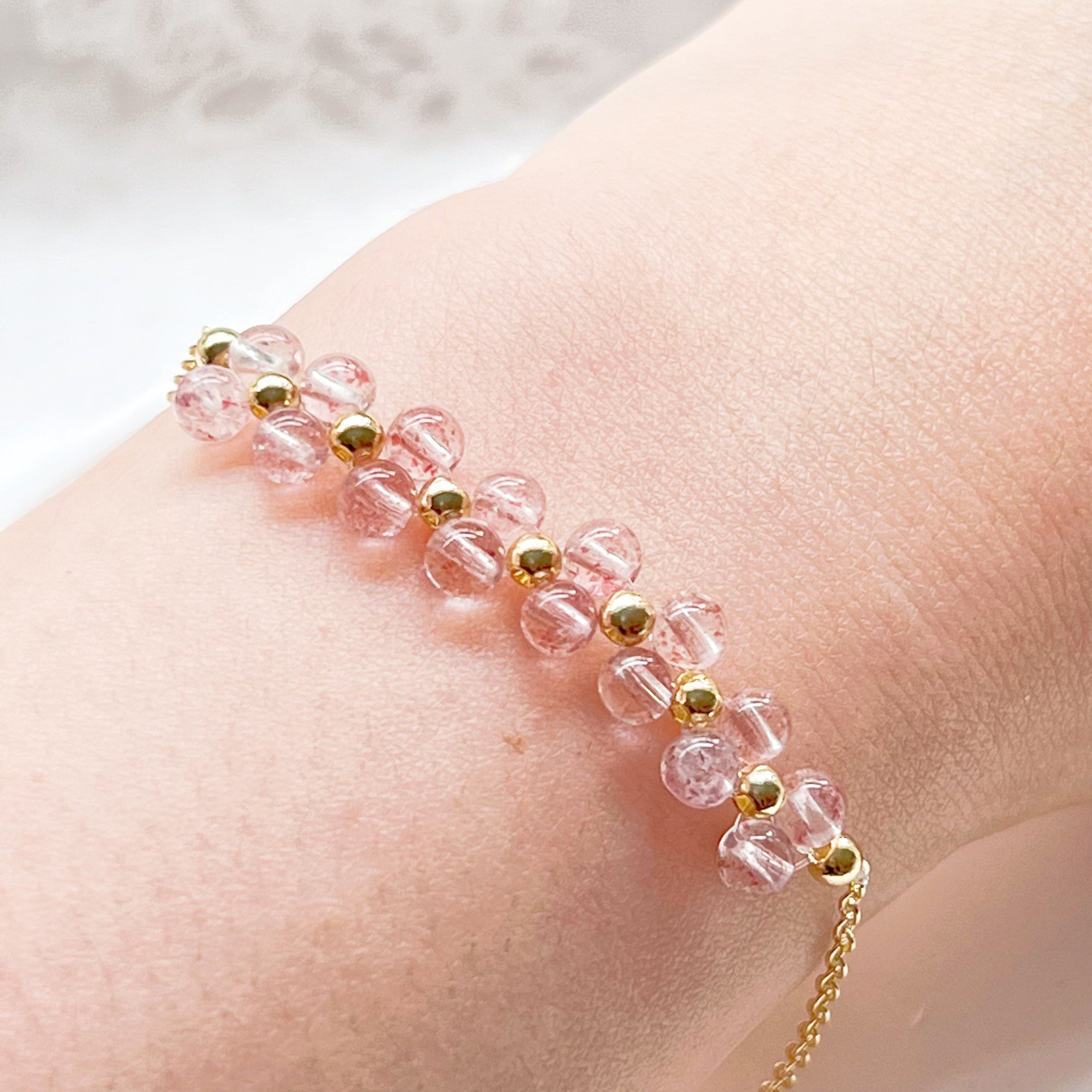 A beautifully handcrafted Strawberry Quartz Cluster Bracelet featuring natural pink quartz beads in a bar shape, elegantly displayed in a gift box.