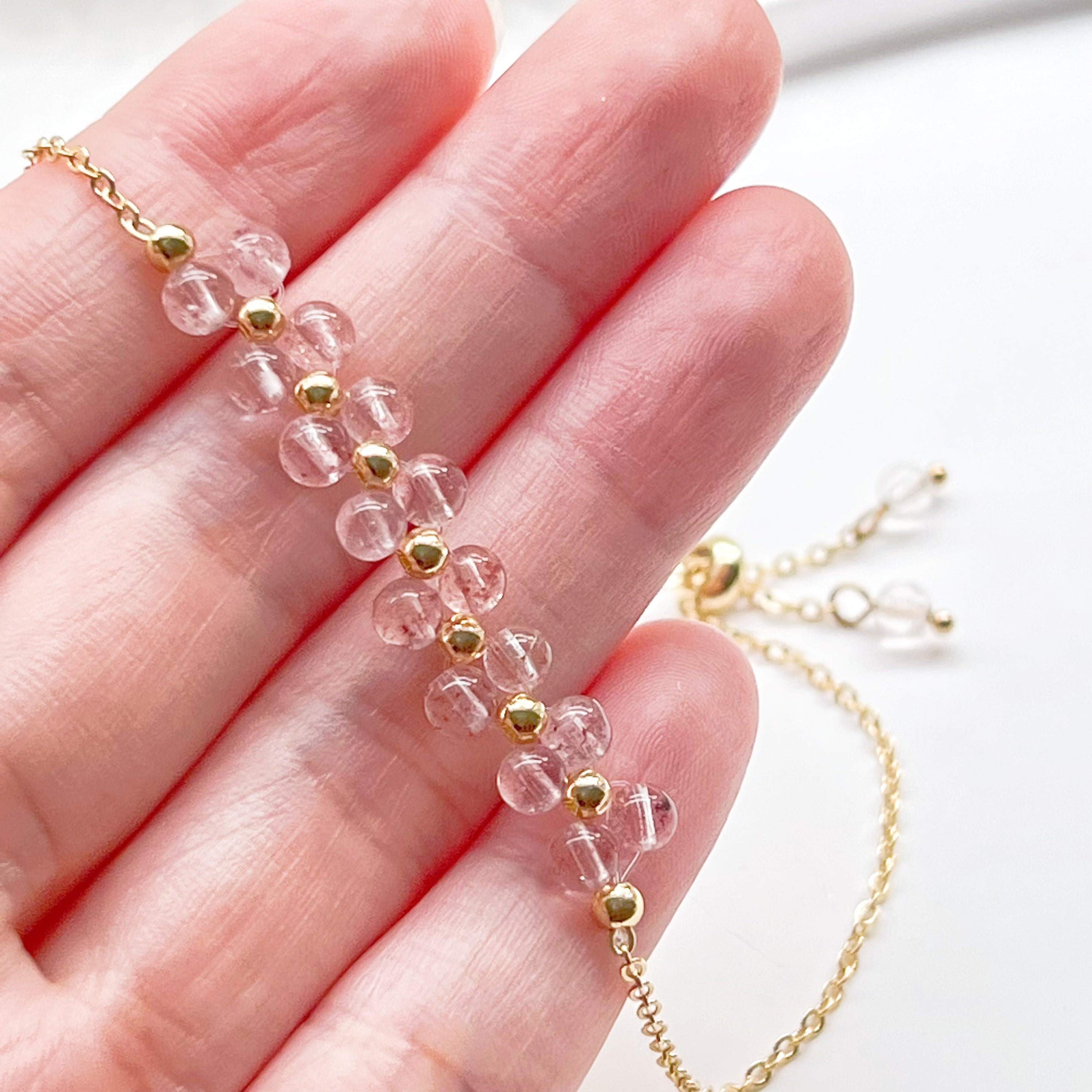 A beautifully handcrafted Strawberry Quartz Cluster Bracelet featuring natural pink quartz beads in a bar shape, elegantly displayed in a gift box.