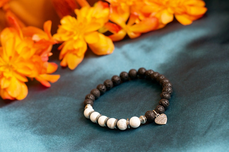 A stylish stretch bracelet made of Howlite and Lava Stone, showcasing natural stone variations and a comfortable fit.