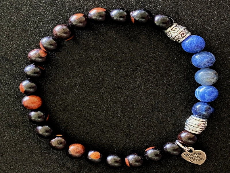 Stretch Bracelet made of Tiger Ebony and Sodalite beads on a stretchy cord, featuring a base metal focal bead and charm.