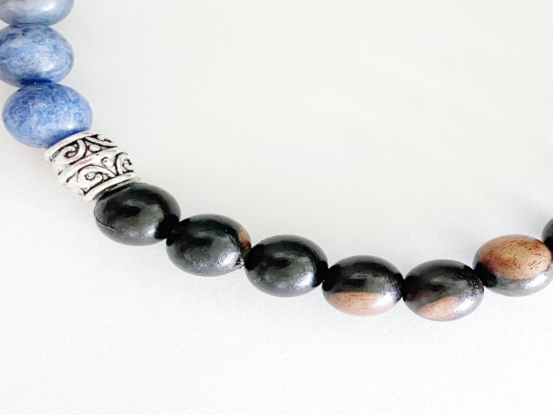 Stretch Bracelet made of Tiger Ebony and Sodalite beads on a stretchy cord, featuring a base metal focal bead and charm.