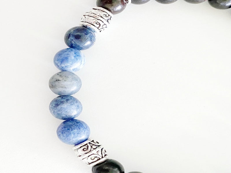 Stretch Bracelet made of Tiger Ebony and Sodalite beads on a stretchy cord, featuring a base metal focal bead and charm.