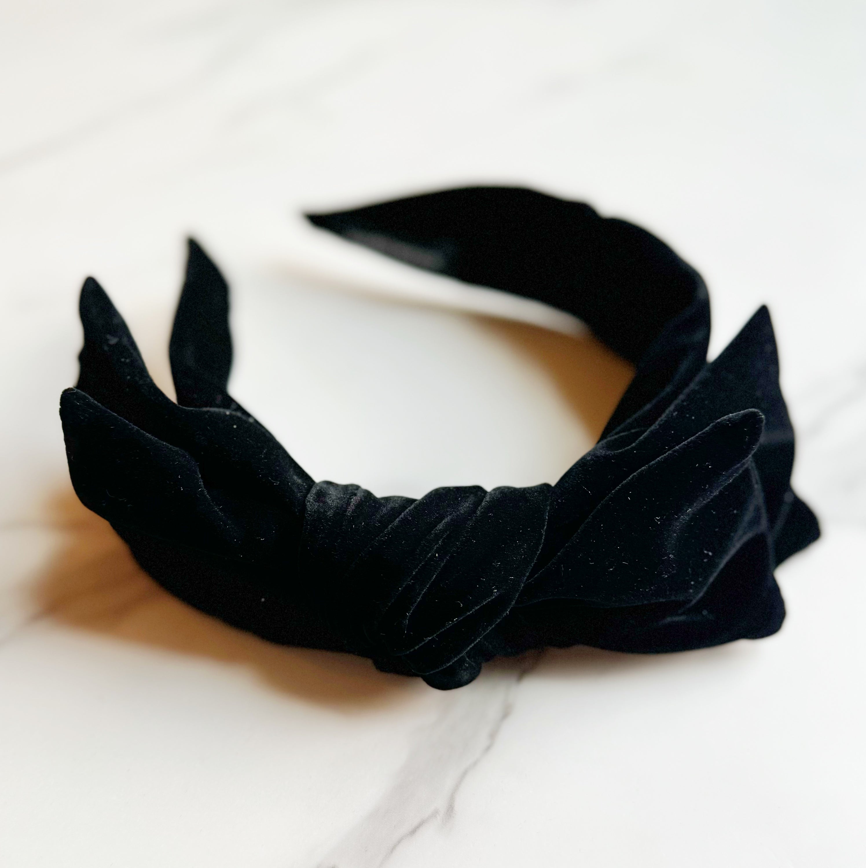 Structured Velvet Bow Headband featuring a sophisticated bow design in rich velvet material, perfect for elevating any outfit.