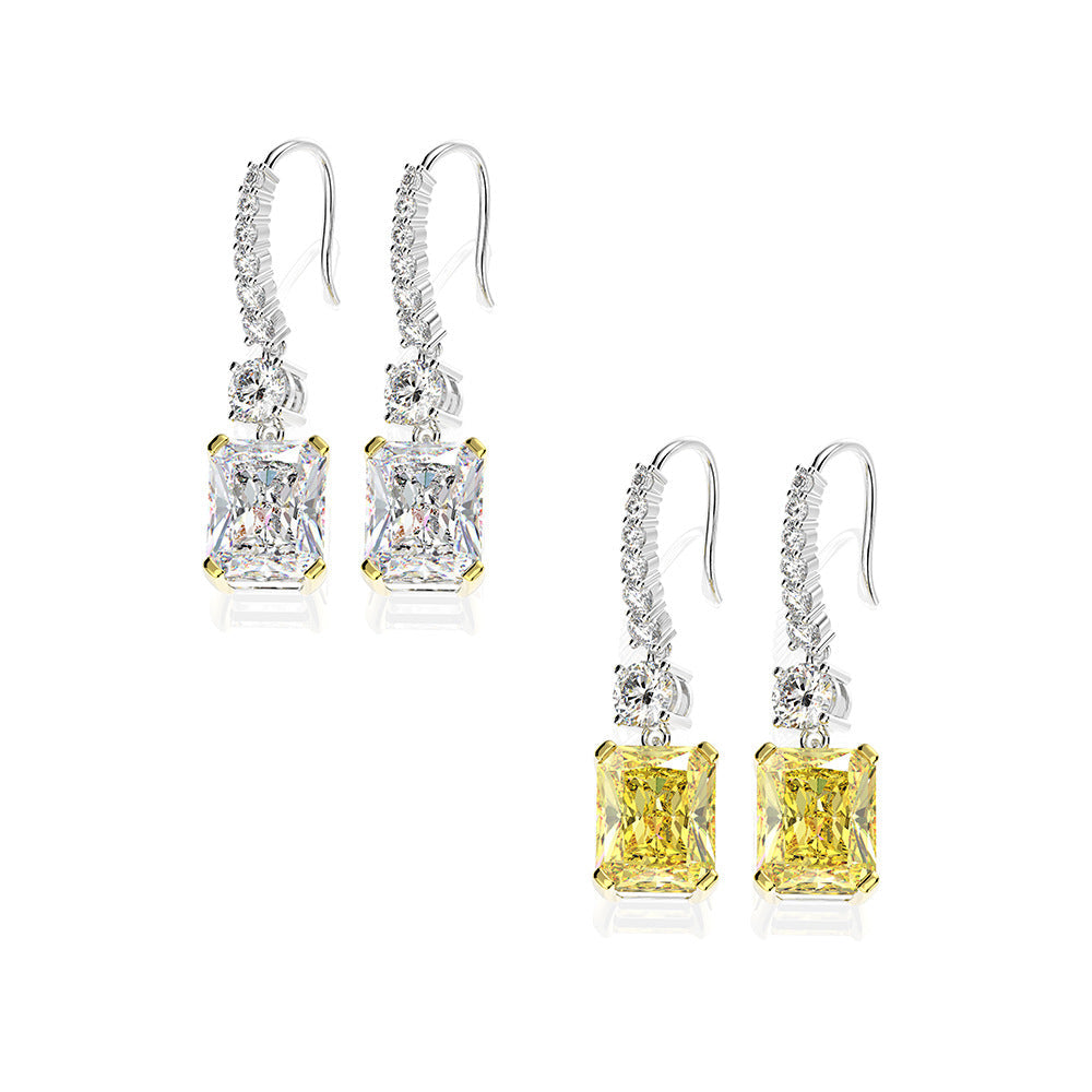 A pair of stunning dainty earrings featuring emerald-cut stones in a 925 sterling silver setting, elegantly dangling from hooks.