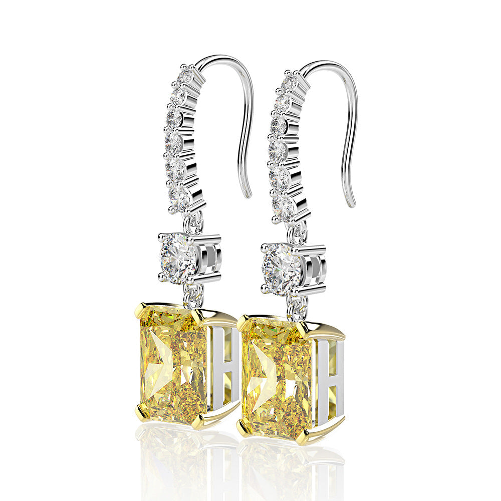 A pair of stunning dainty earrings featuring emerald-cut stones in a 925 sterling silver setting, elegantly dangling from hooks.