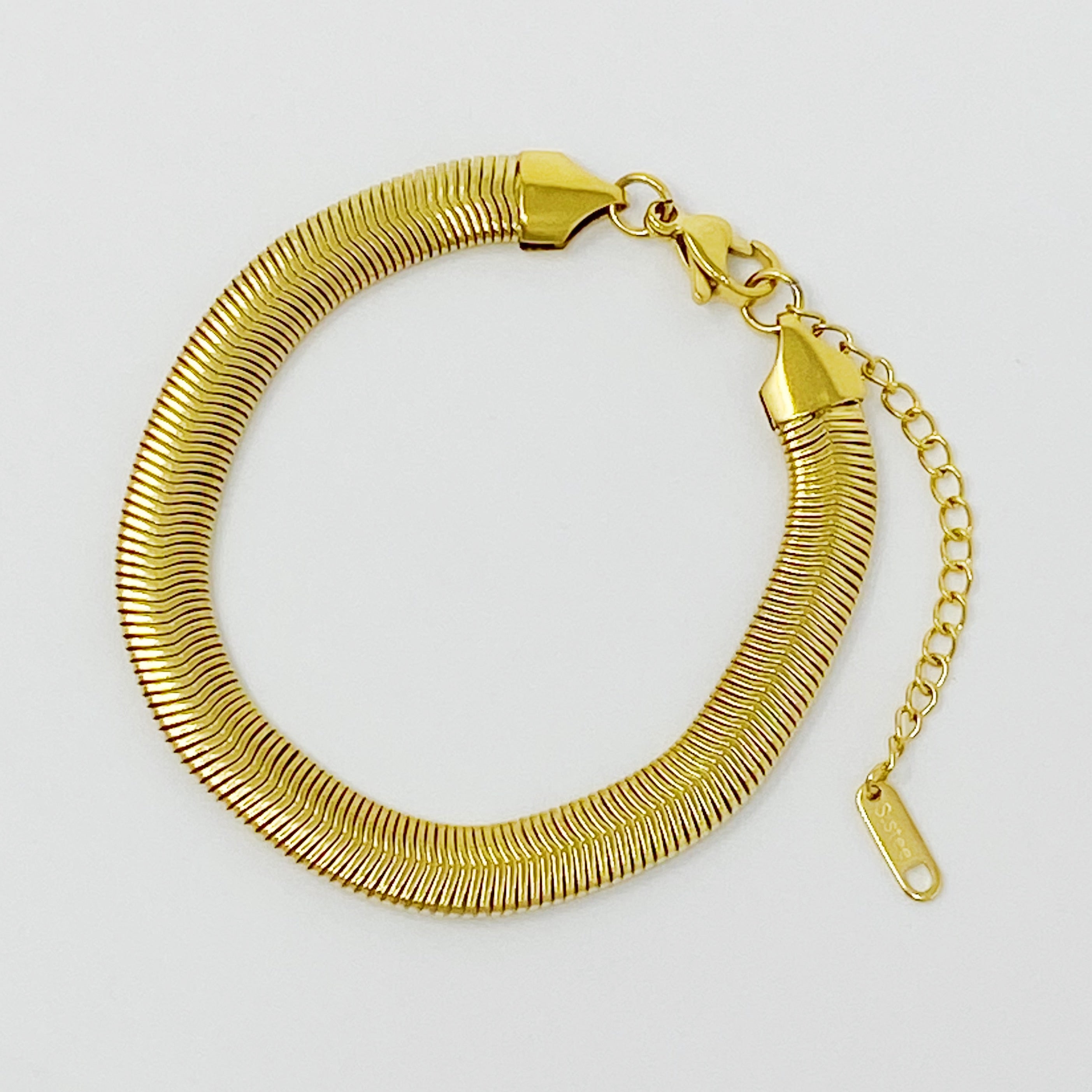 A stylish gold plated herringbone chain bracelet with a 2-inch extender, showcasing its elegant design and quality craftsmanship.