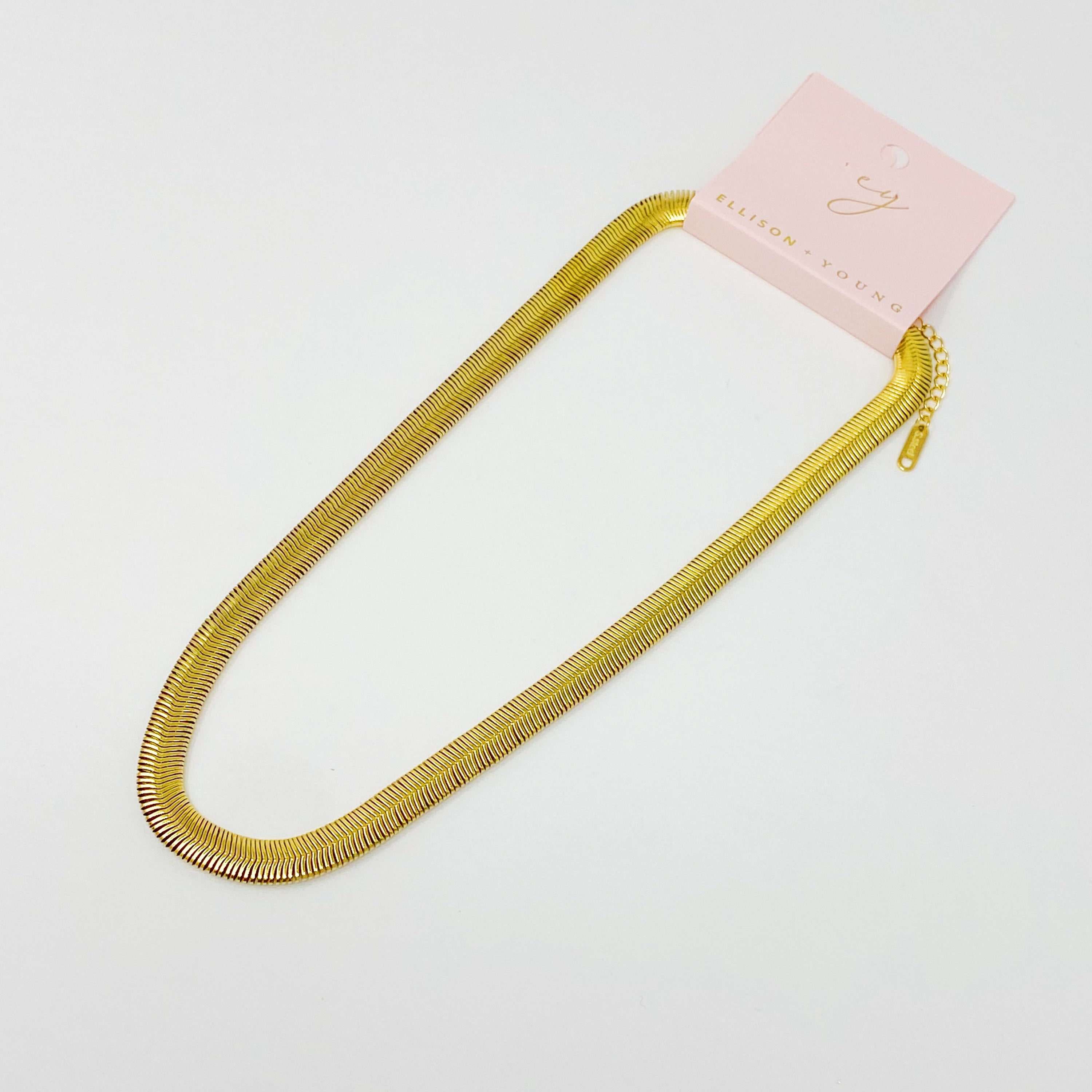 A stylish gold plated herringbone chain necklace with a 16-inch length and 2-inch extender, showcasing its elegant design.