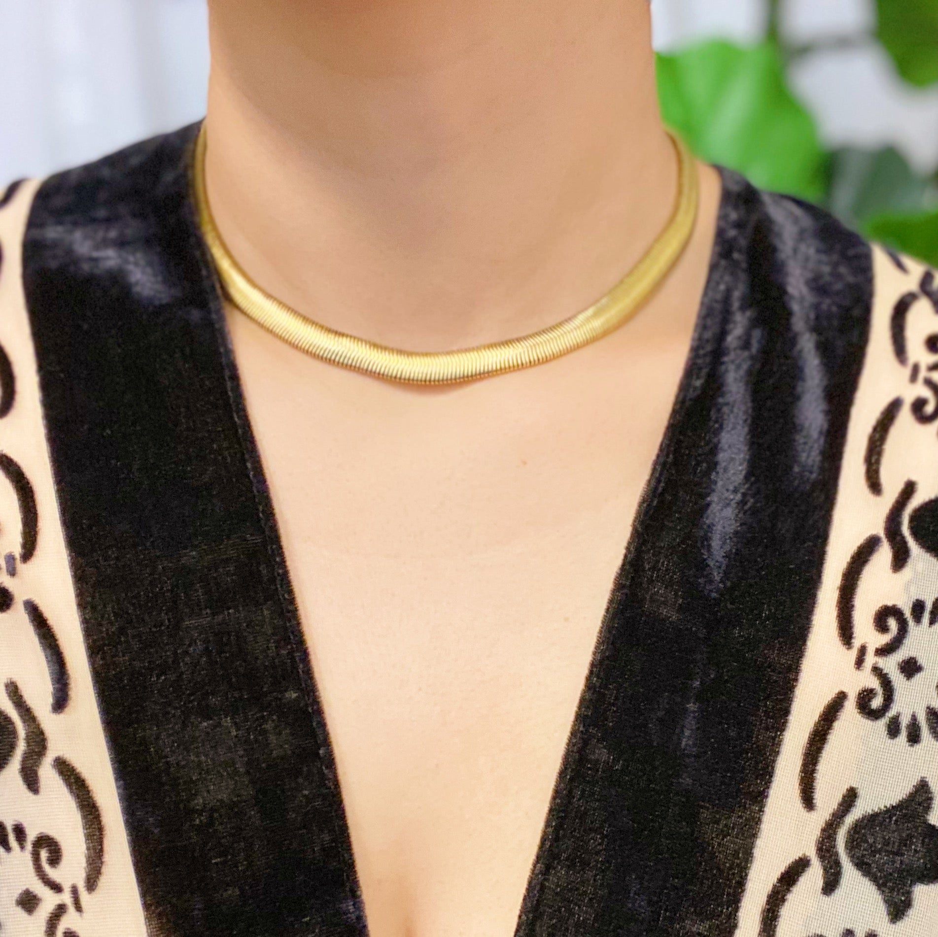 A stylish gold plated herringbone chain necklace with a 16-inch length and 2-inch extender, showcasing its elegant design.