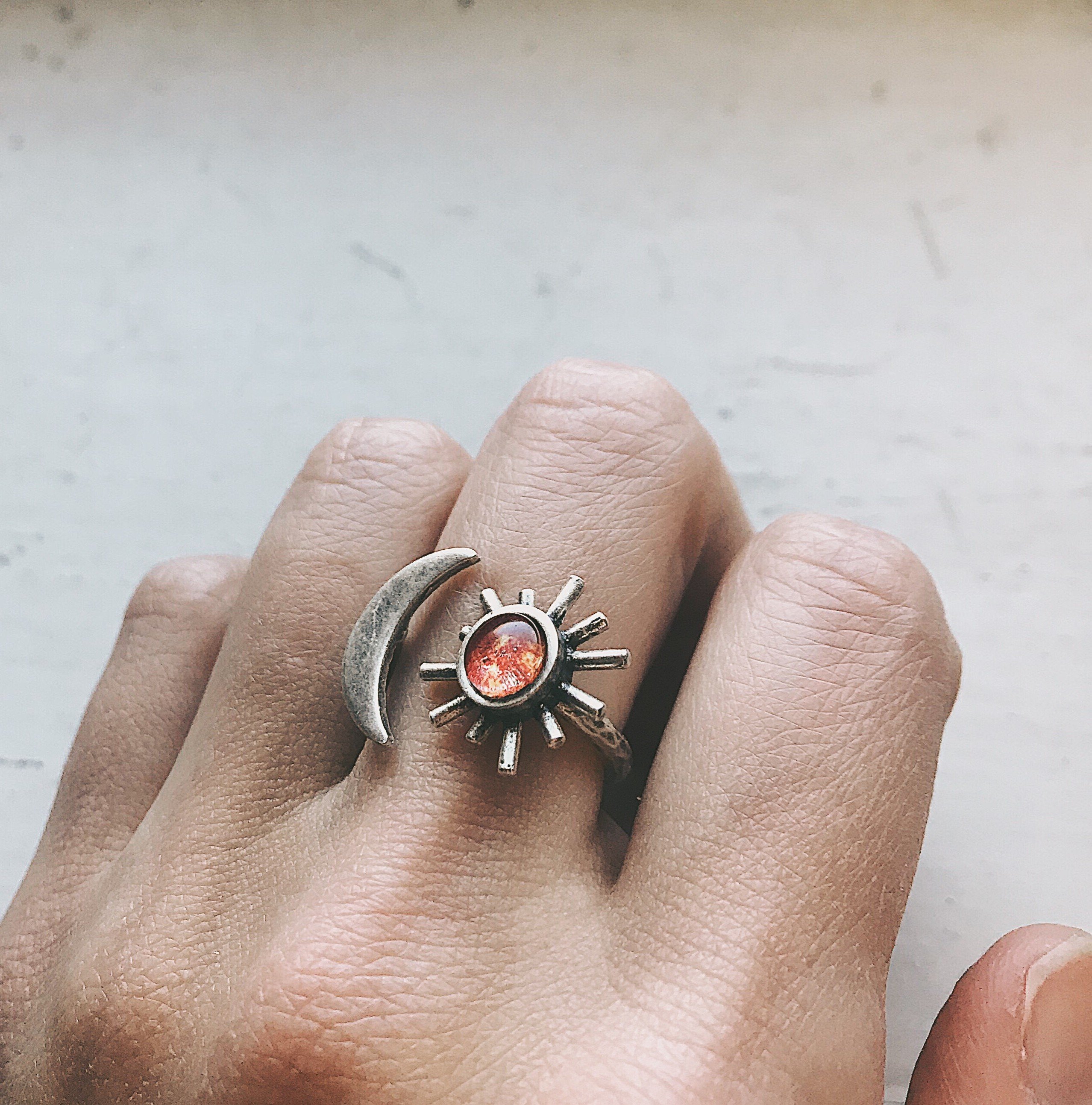 A beautifully handcrafted Sun and Moon Sculptural Statement Ring featuring a vibrant sun and serene moon design, available in silver or gold tone.