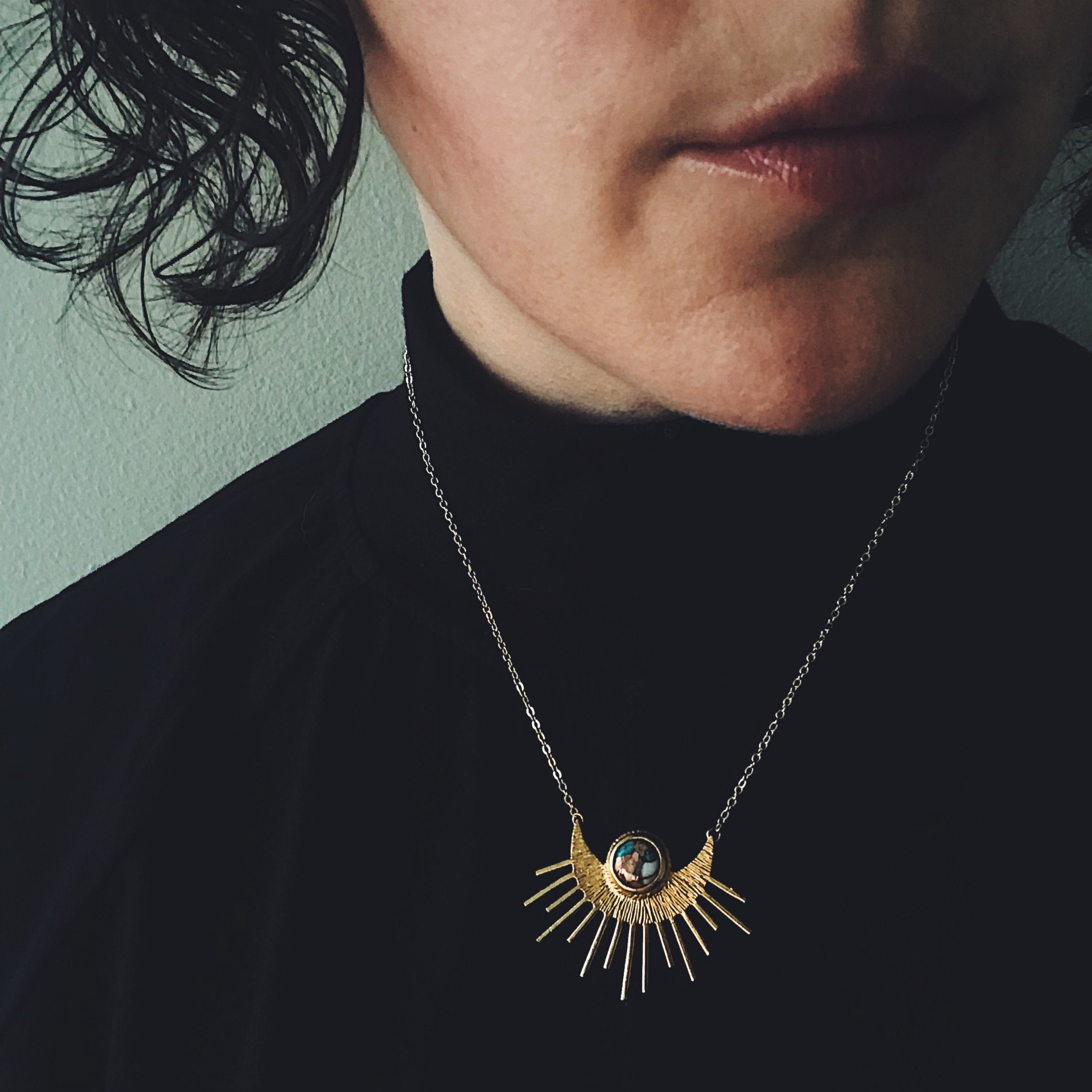 Sun Goddess Necklace featuring a half sunburst pendant with copper oyster turquoise in vibrant colors, set in textured gold tone.