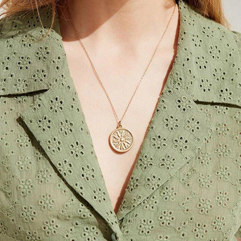 A beautiful Sun Pendant Necklace featuring a gold plated brass chain and a 2 cm sun coin charm, elegantly displayed in a gift box.