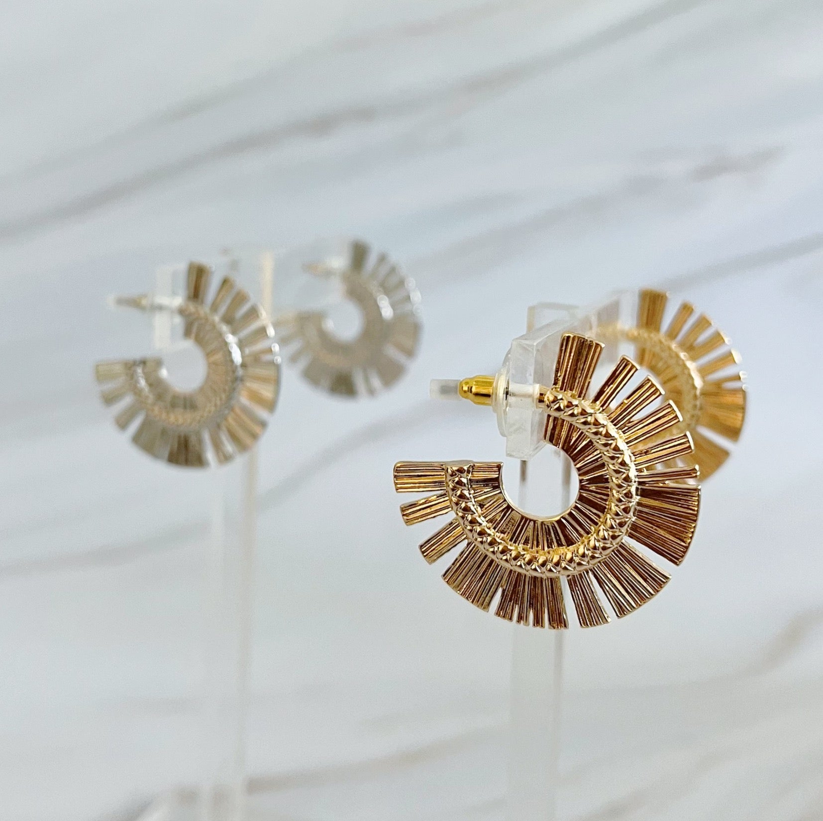 A pair of Sunburst Beauty Hoop Earrings featuring a unique sunburst design, made from plated alloy metal with a 1-inch diameter.