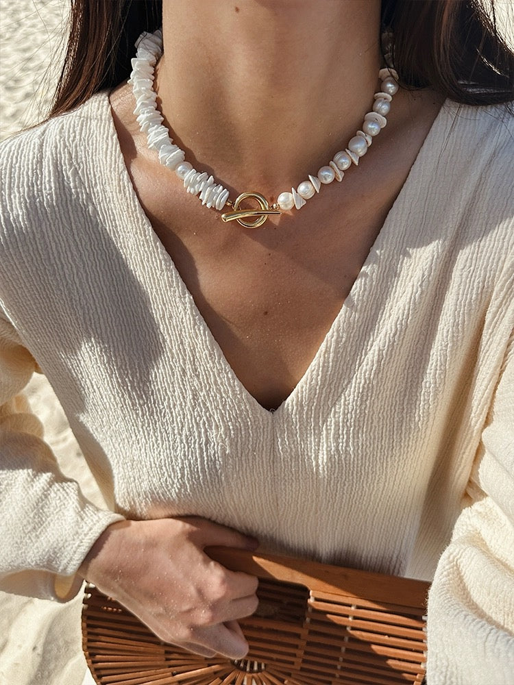 Sunlit Seashells Pink and White Beach Bliss Necklace featuring natural freshwater pearls, conch slices, and shells, embodying summer elegance.