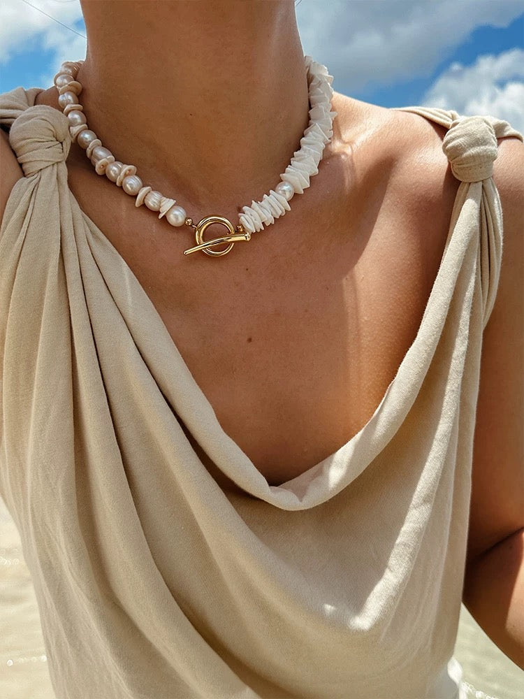 Sunlit Seashells Pink and White Beach Bliss Necklace featuring natural freshwater pearls, conch slices, and shells, embodying summer elegance.