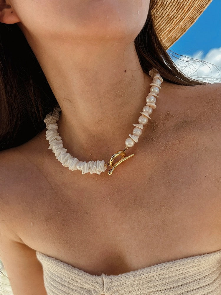 Sunlit Seashells Pink and White Beach Bliss Necklace featuring natural freshwater pearls, conch slices, and shells, embodying summer elegance.