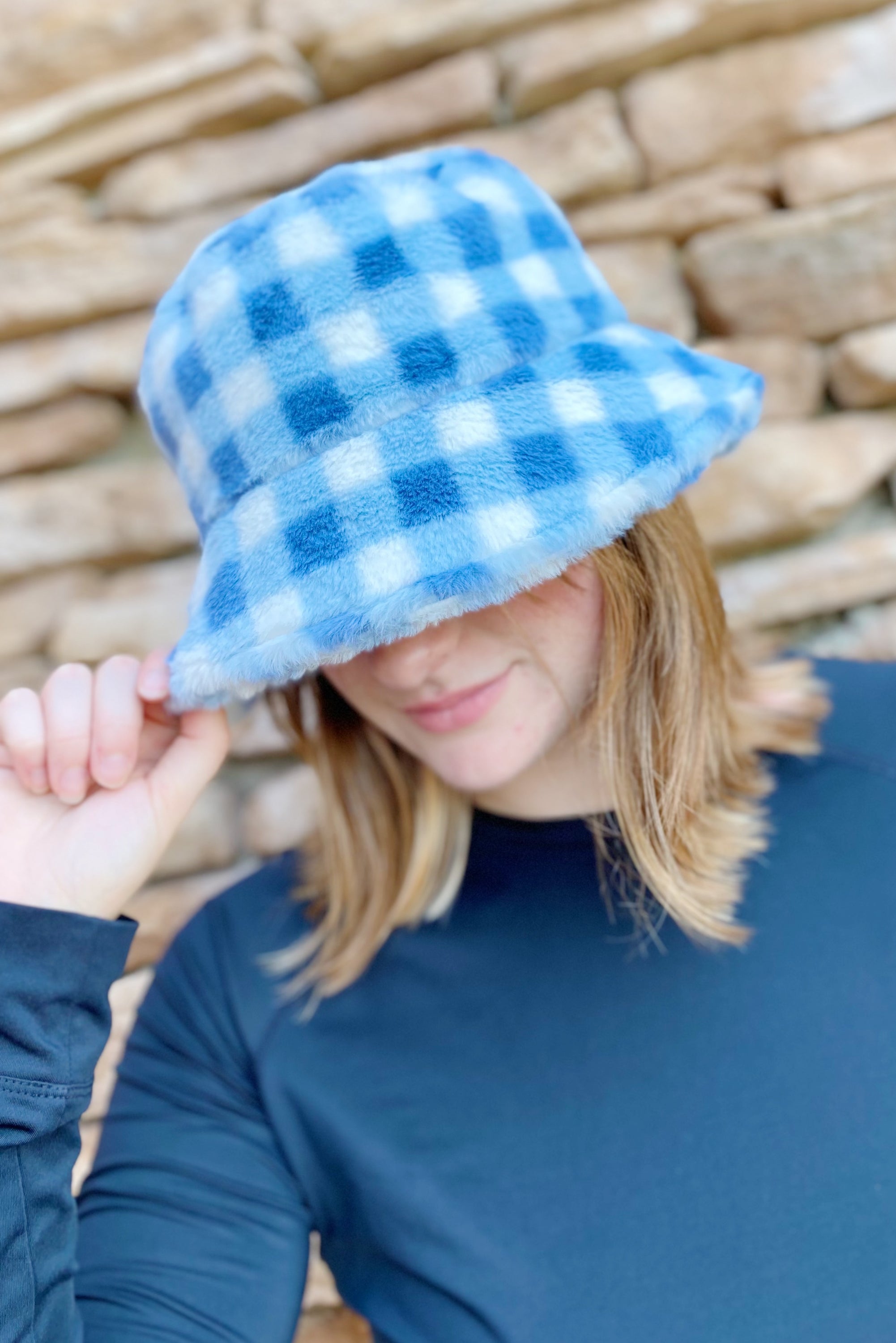 A stylish Super Cozy Checkered Bucket Hat with a furry texture and trendy checkered pattern, perfect for warmth and fashion.