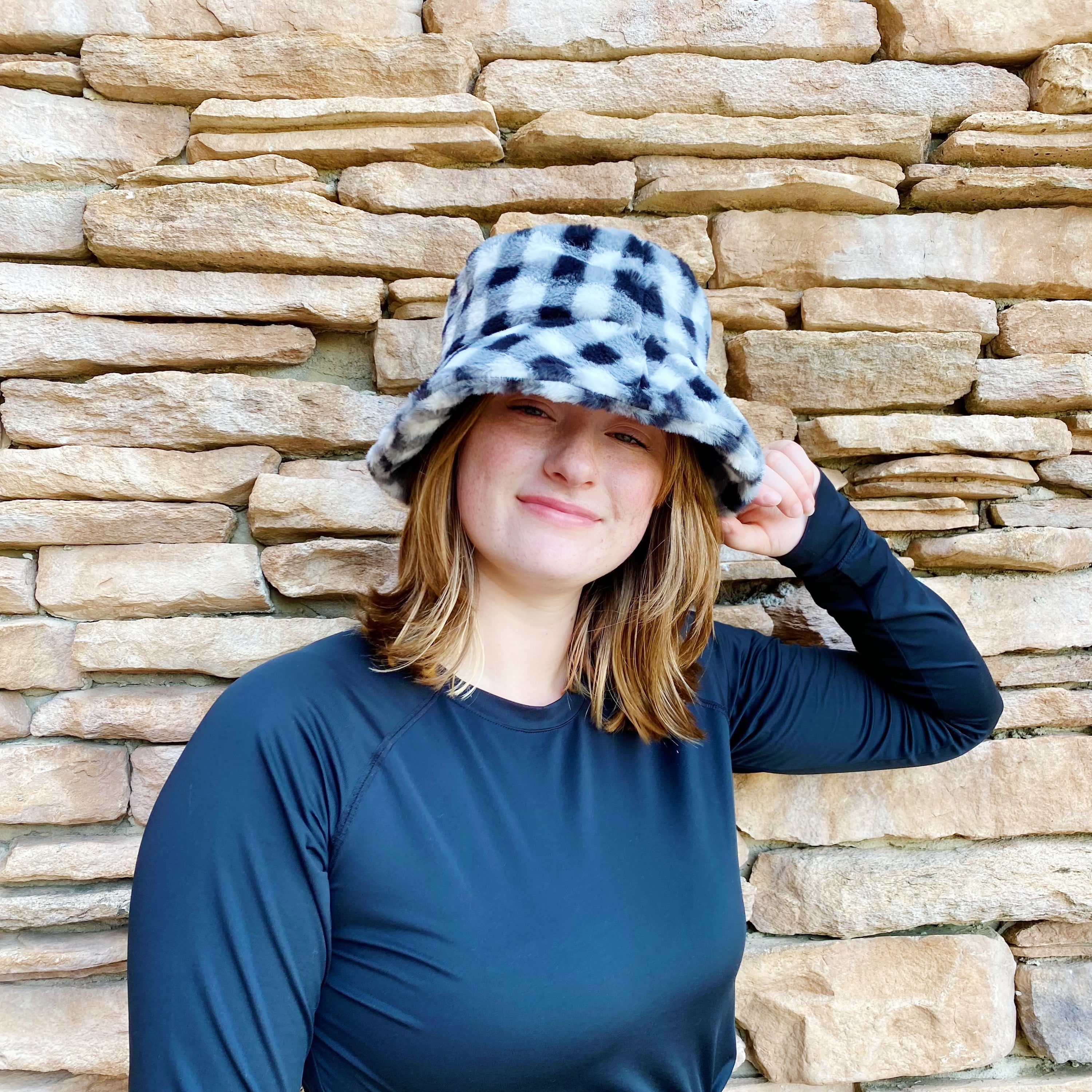 A stylish Super Cozy Checkered Bucket Hat with a furry texture and trendy checkered pattern, perfect for warmth and fashion.