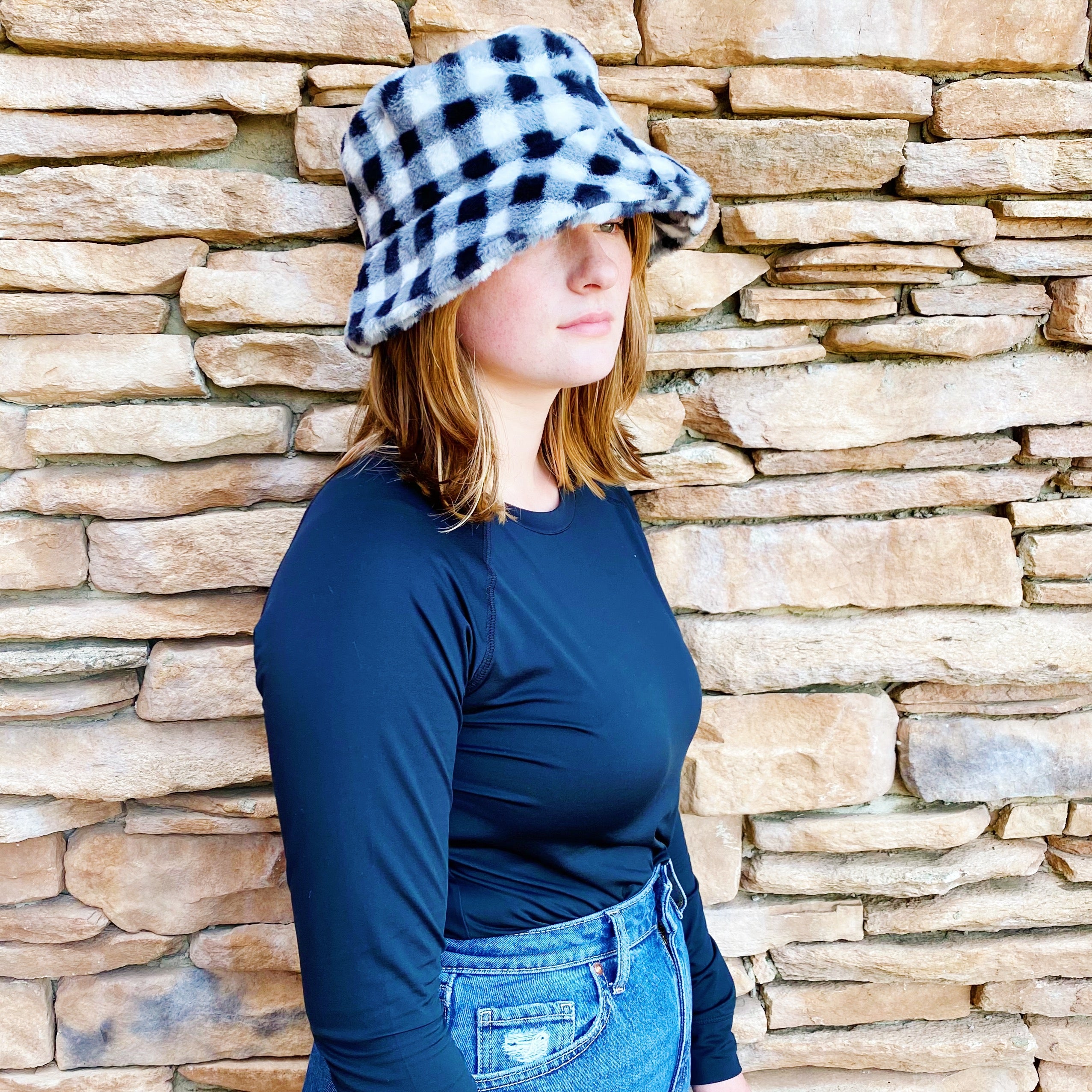 A stylish Super Cozy Checkered Bucket Hat with a furry texture and trendy checkered pattern, perfect for warmth and fashion.