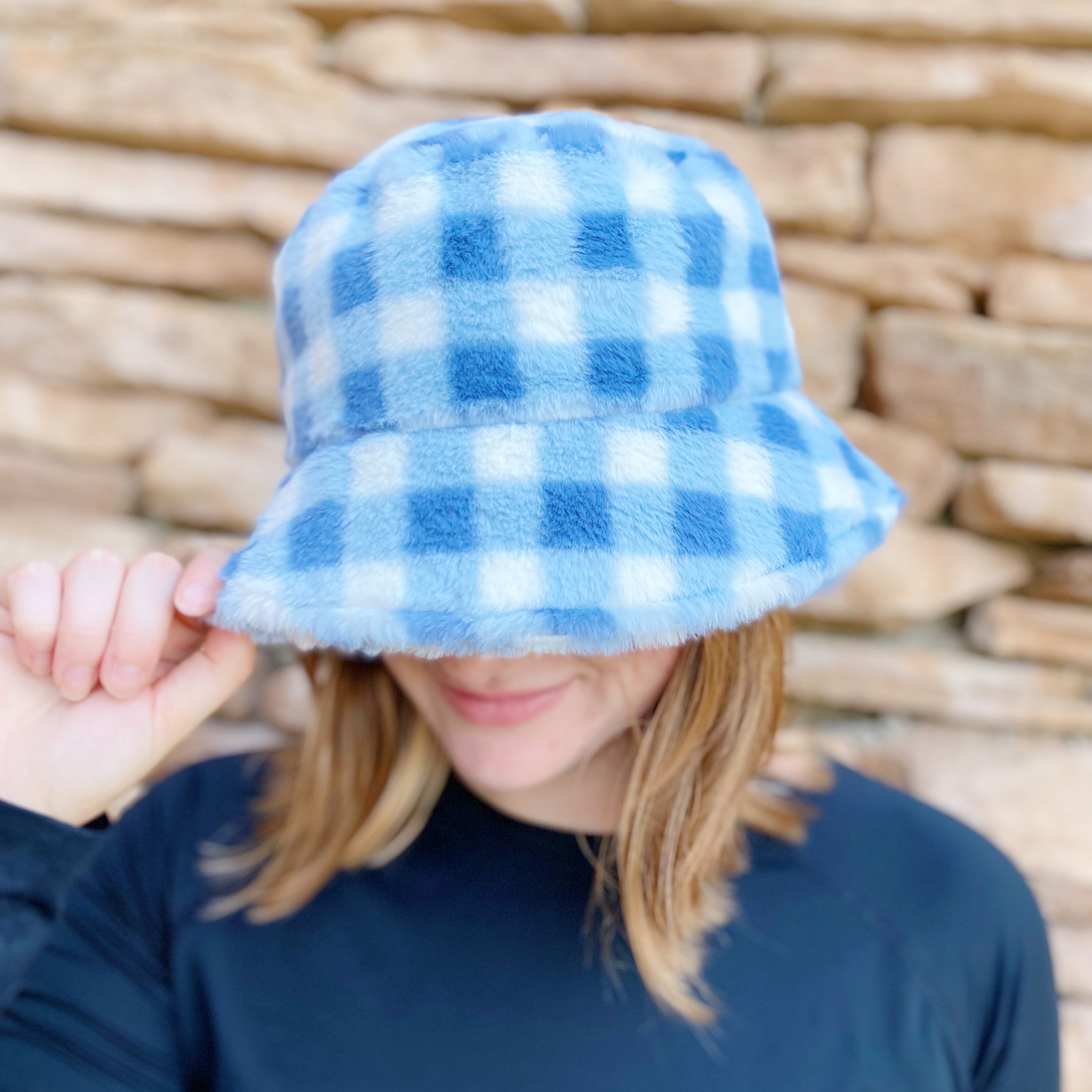 A stylish Super Cozy Checkered Bucket Hat with a furry texture and trendy checkered pattern, perfect for warmth and fashion.