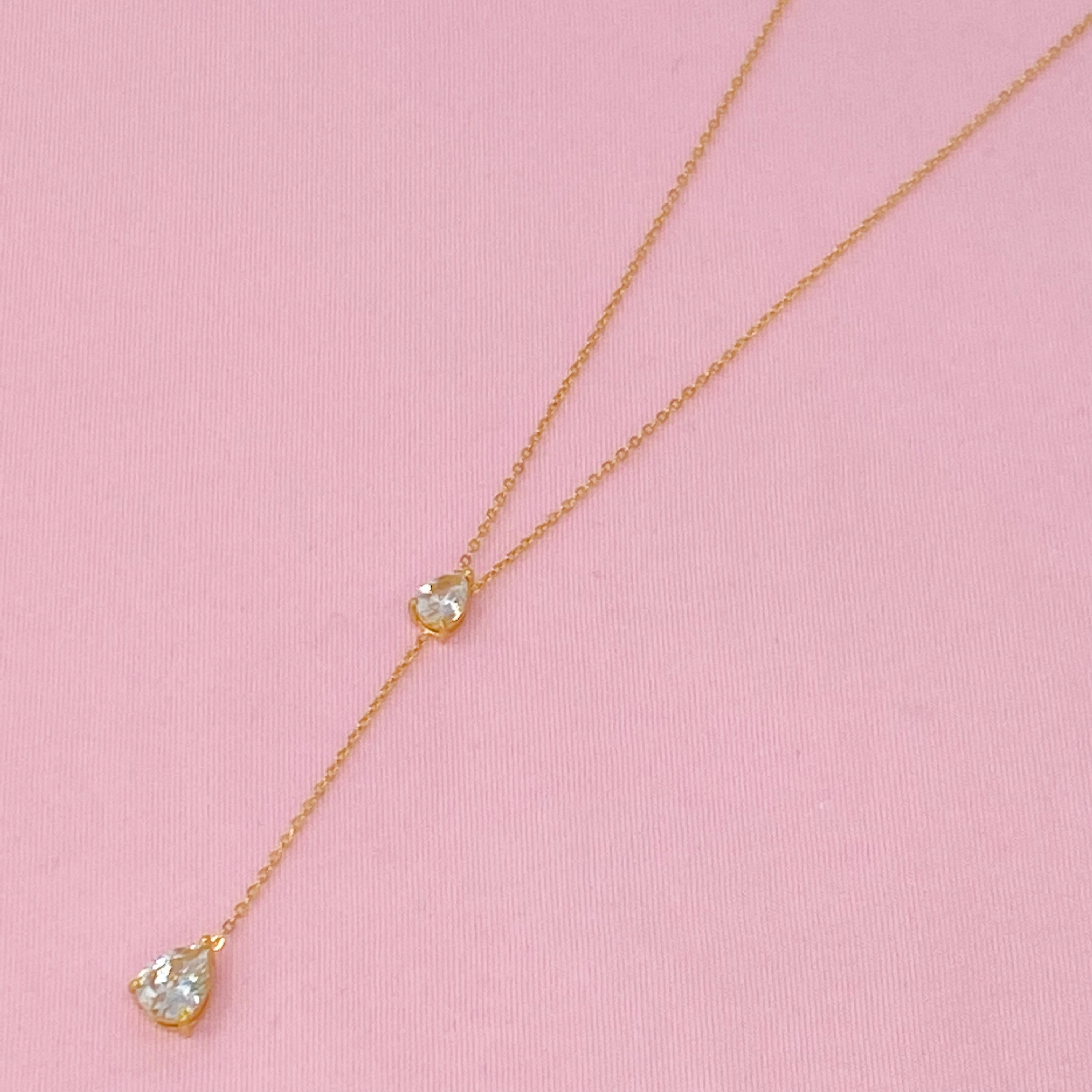 A beautiful Superior Shine Drop Necklace featuring two tear drop Cubic Zirconia stones on a dainty 18k gold plated stainless steel chain.