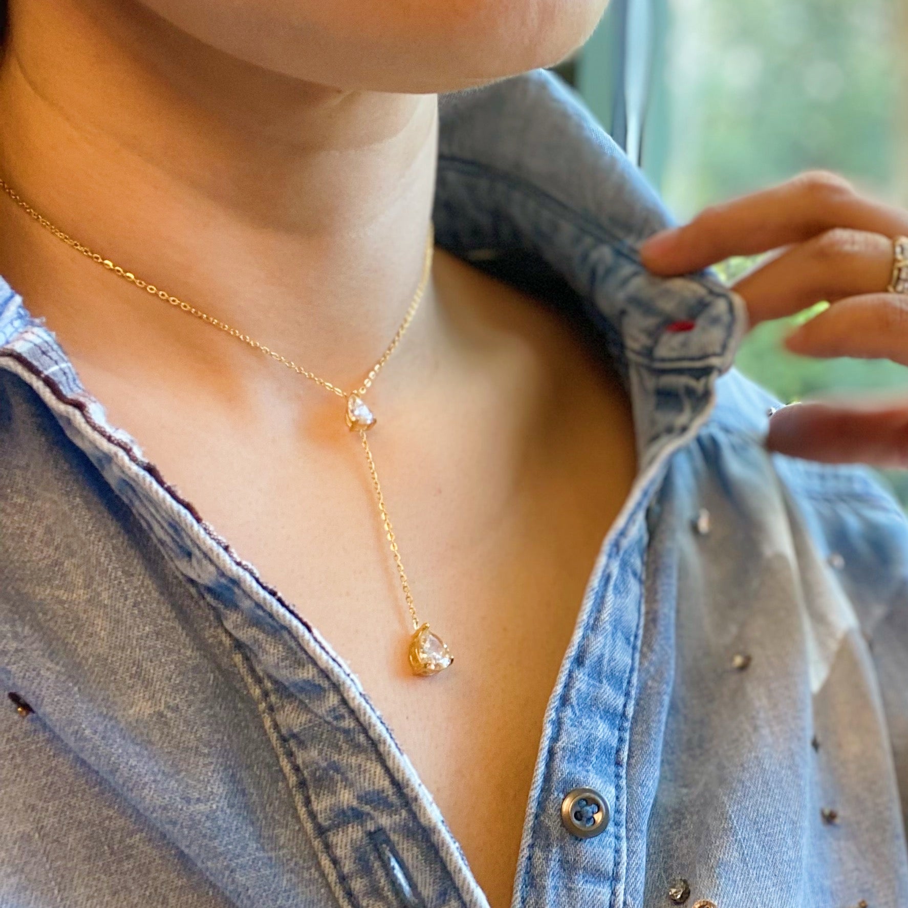 A beautiful Superior Shine Drop Necklace featuring two tear drop Cubic Zirconia stones on a dainty 18k gold plated stainless steel chain.