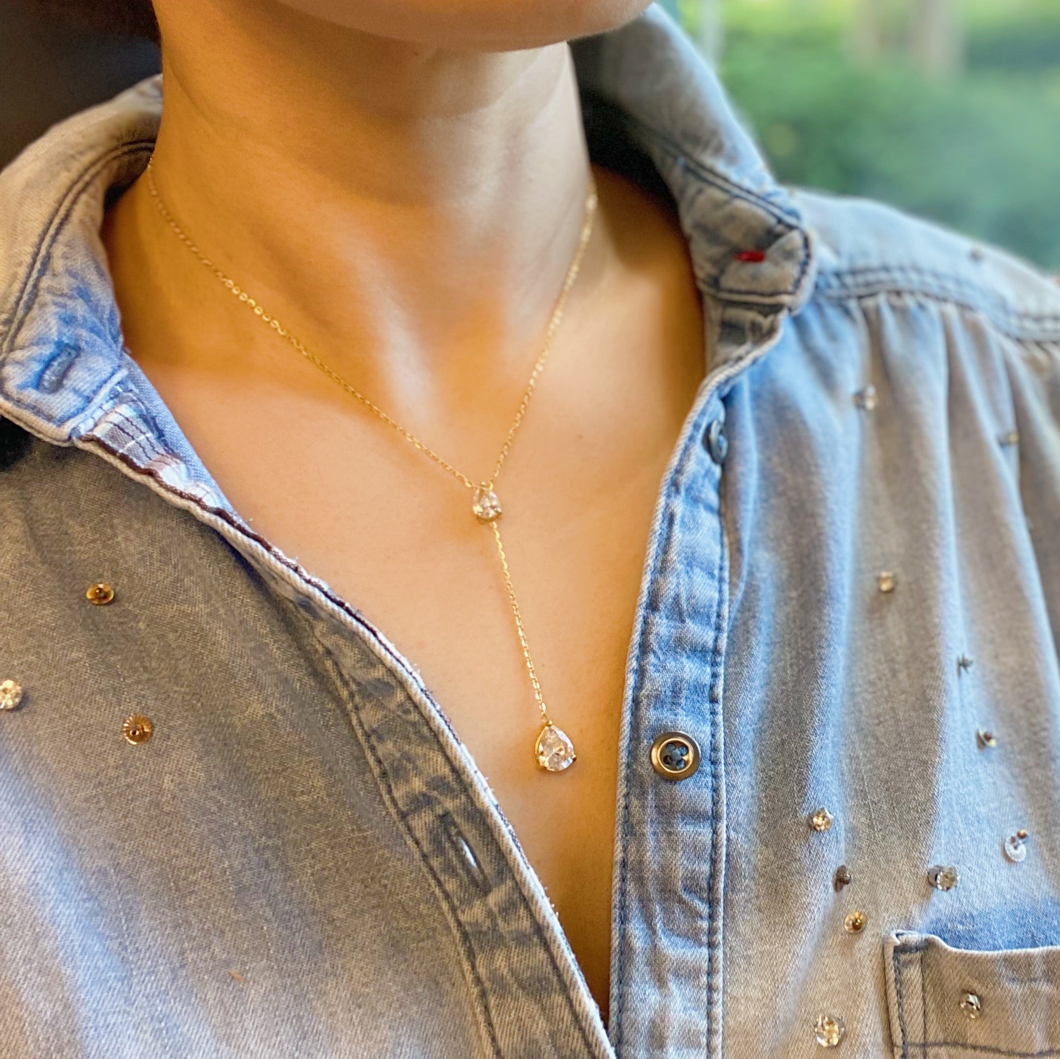 A beautiful Superior Shine Drop Necklace featuring two tear drop Cubic Zirconia stones on a dainty 18k gold plated stainless steel chain.