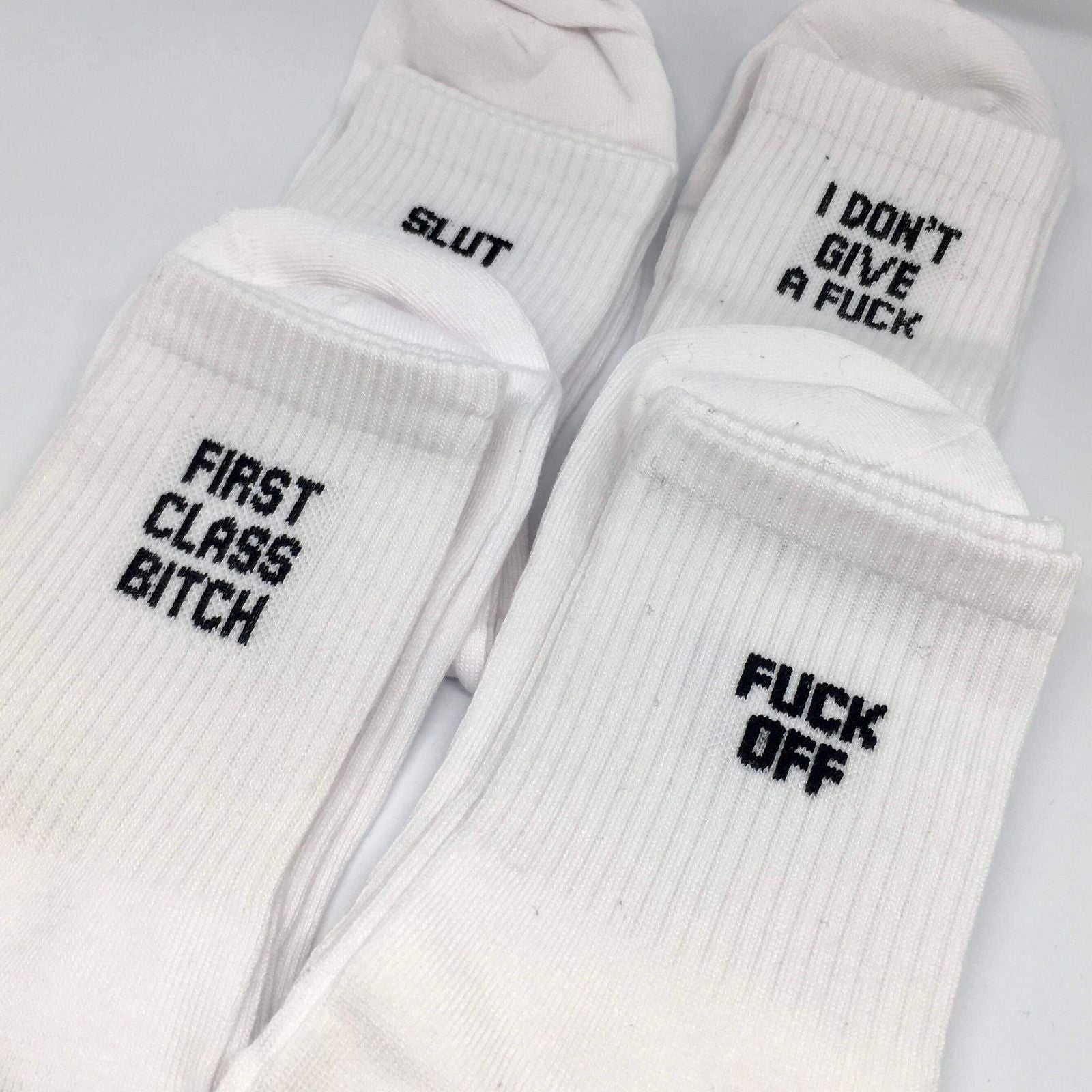 A pair of colorful cotton socks featuring playful swear words, showcasing a fun and quirky design suitable for all occasions.