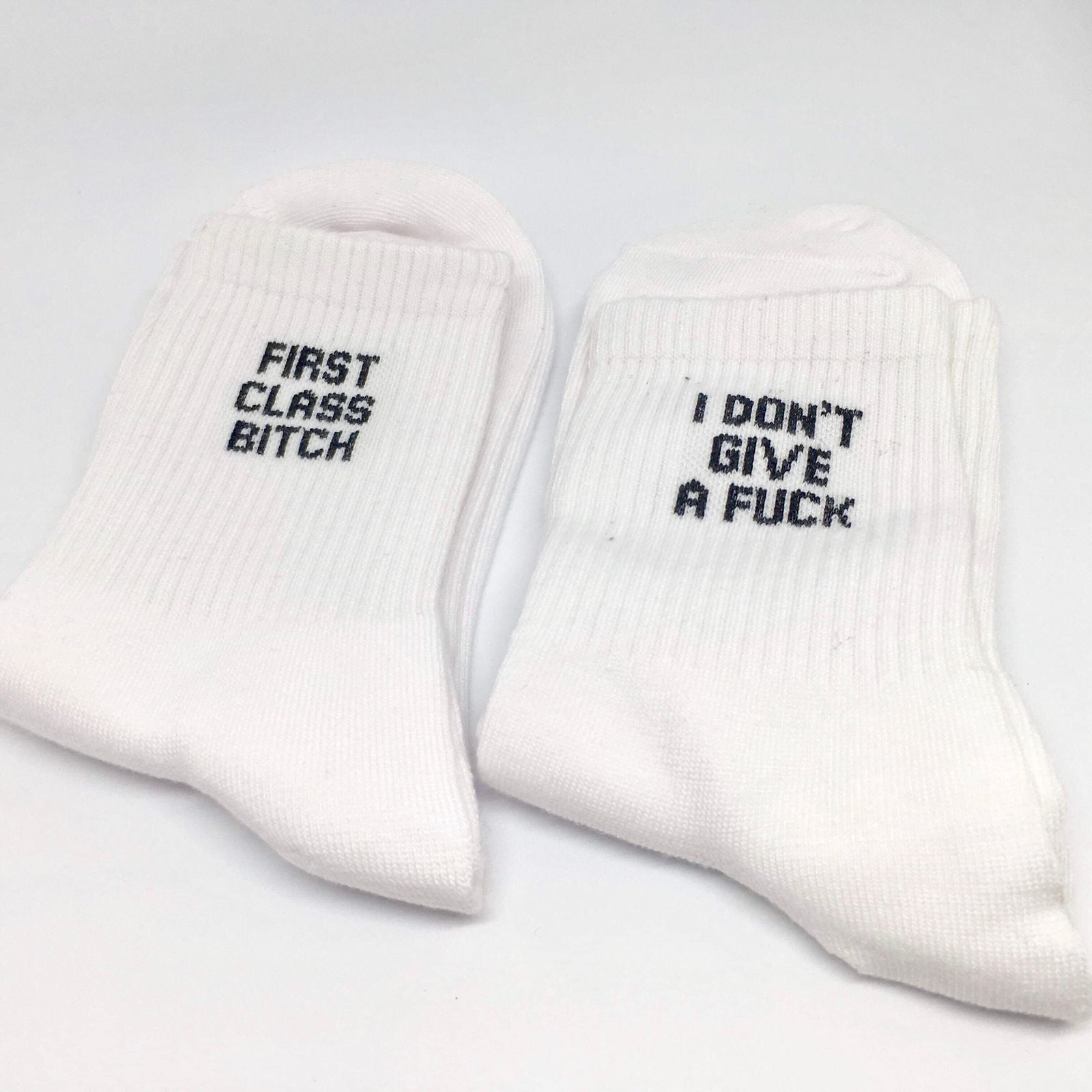 A pair of colorful cotton socks featuring playful swear words, showcasing a fun and quirky design suitable for all occasions.