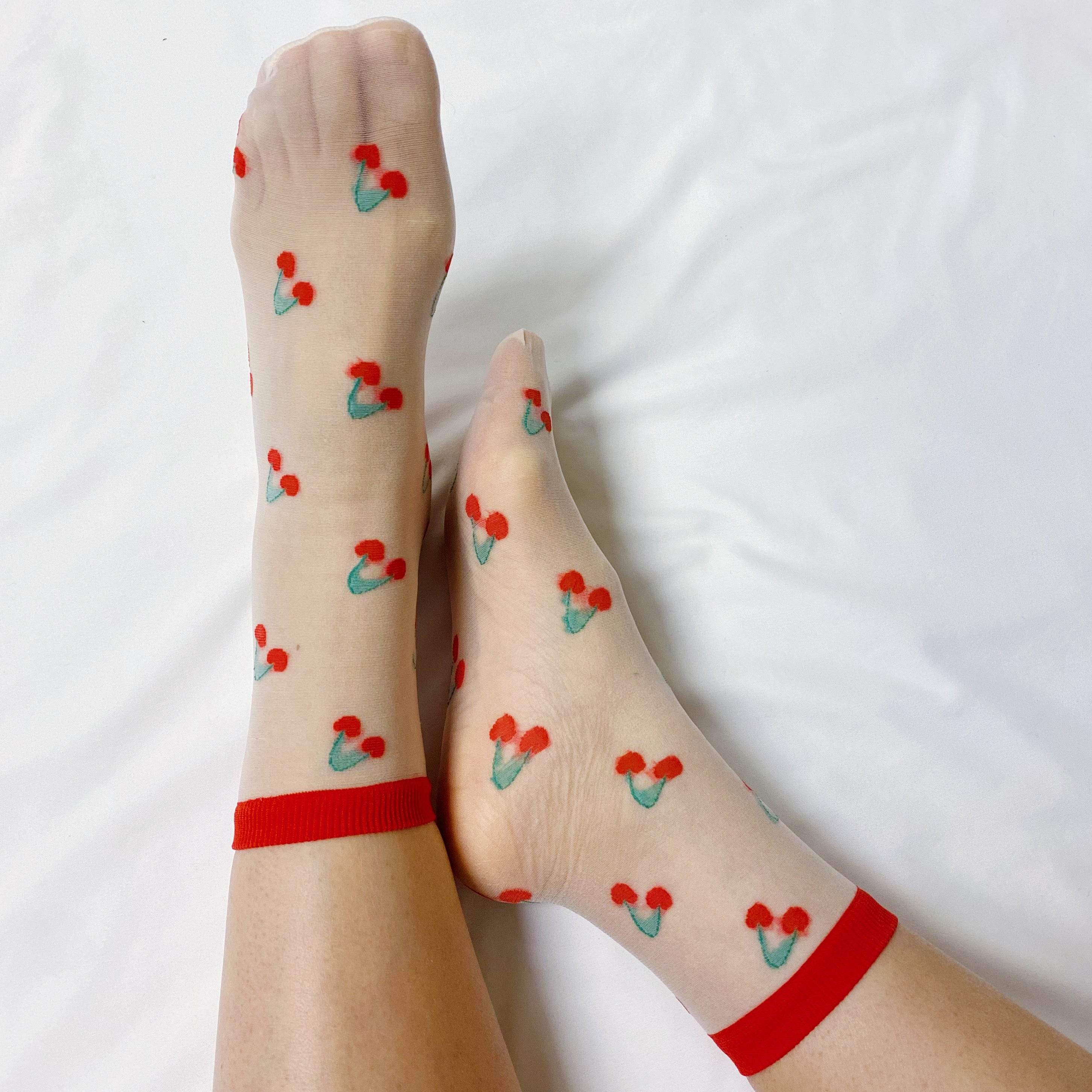 Set of two pairs of sheer socks featuring colorful fruit designs, lightweight and stylish.