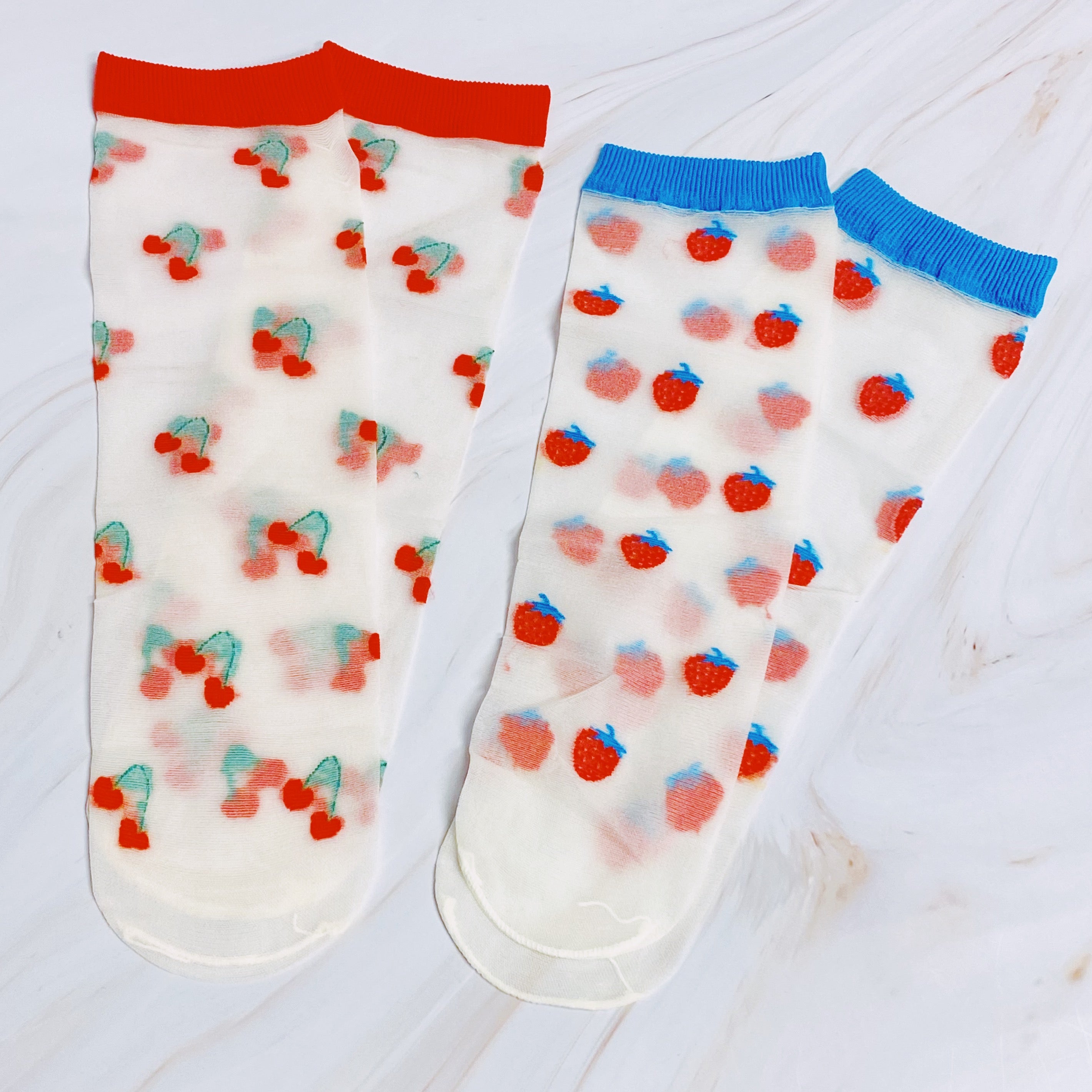 Set of two pairs of sheer socks featuring colorful fruit designs, lightweight and stylish.